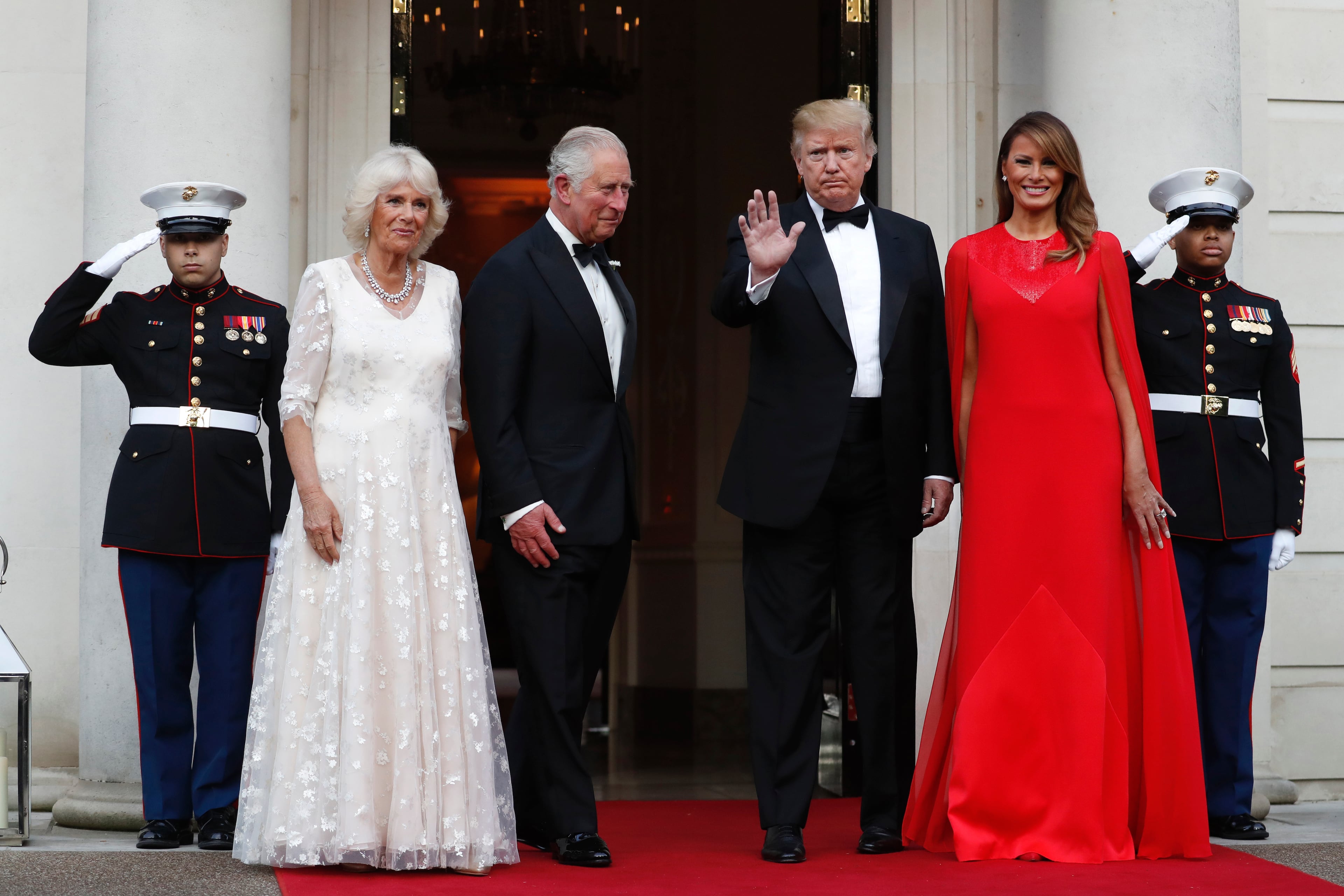 Britain's Prince Charles, centre left and Camilla, the Duchess of Cornwall, second left are greeted by US President Donald Trump and first lady Melania Trump, outside Winfield House, the residence of the Ambassador of the United States of America to the UK, in Regent's Park, for the Return Dinner as part of his state visit to the UK, in London, Tuesday June 4, 2019. (AP Photo/Alastair Grant)
