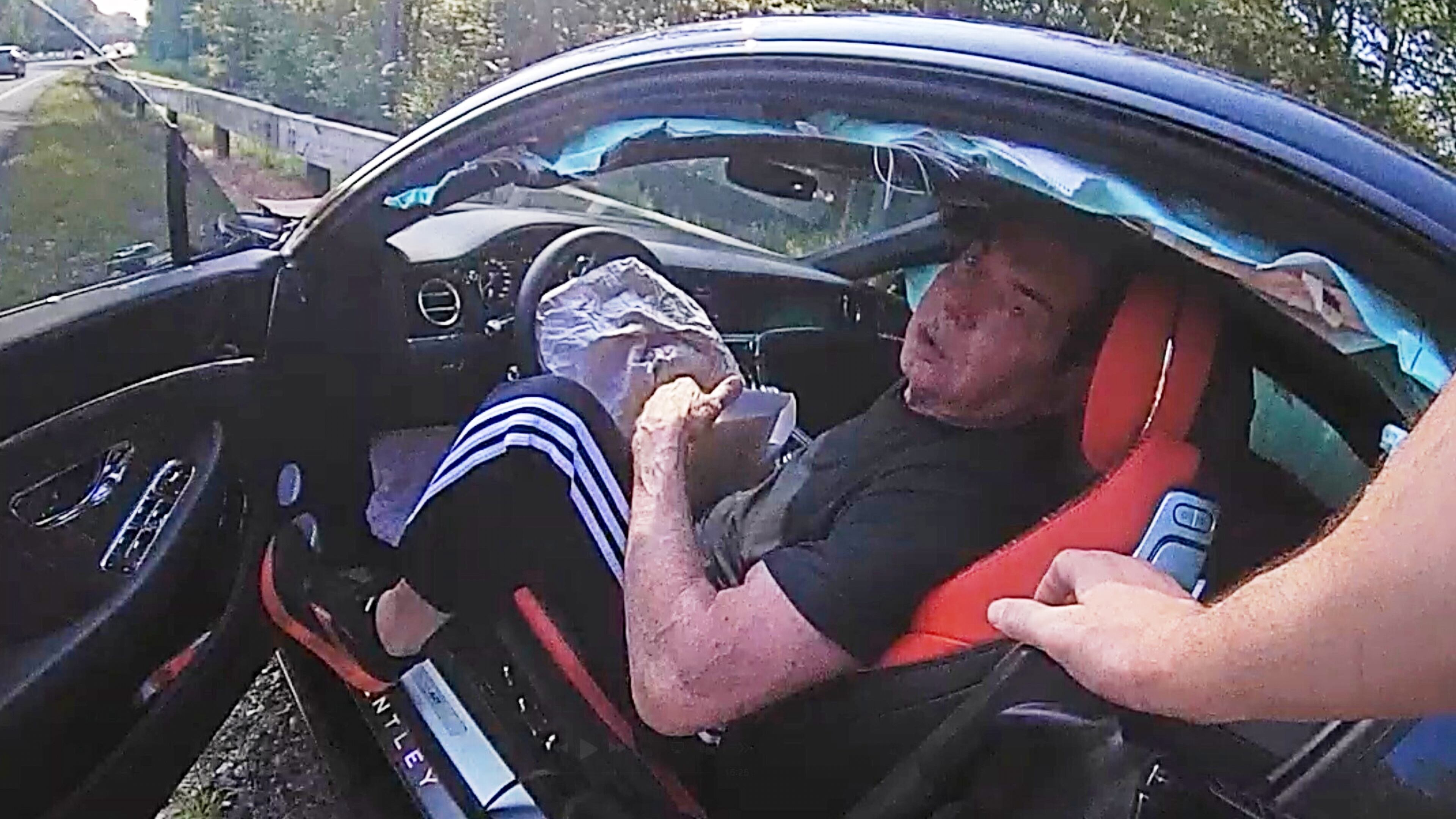 In an image taken from Connecticut State Police police bodycam video, Vince McMahon is questioned in his car after an accident on July 24, 2025, in Westport, Conn. (Connecticut State Police via AP)