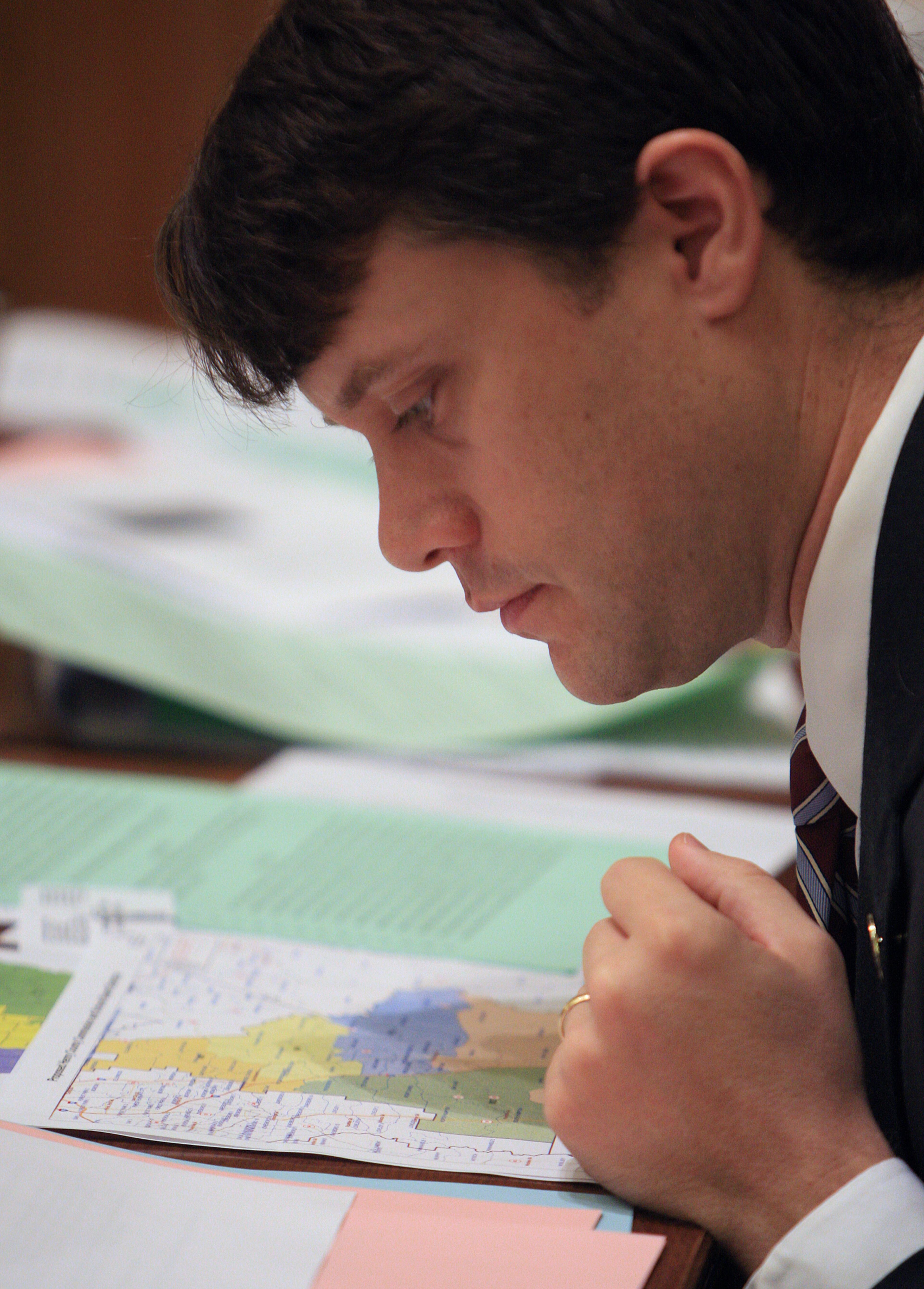 Jason Carter looks closely at the political maps during the debate over the redistricting process on Aug. 31, 2011.