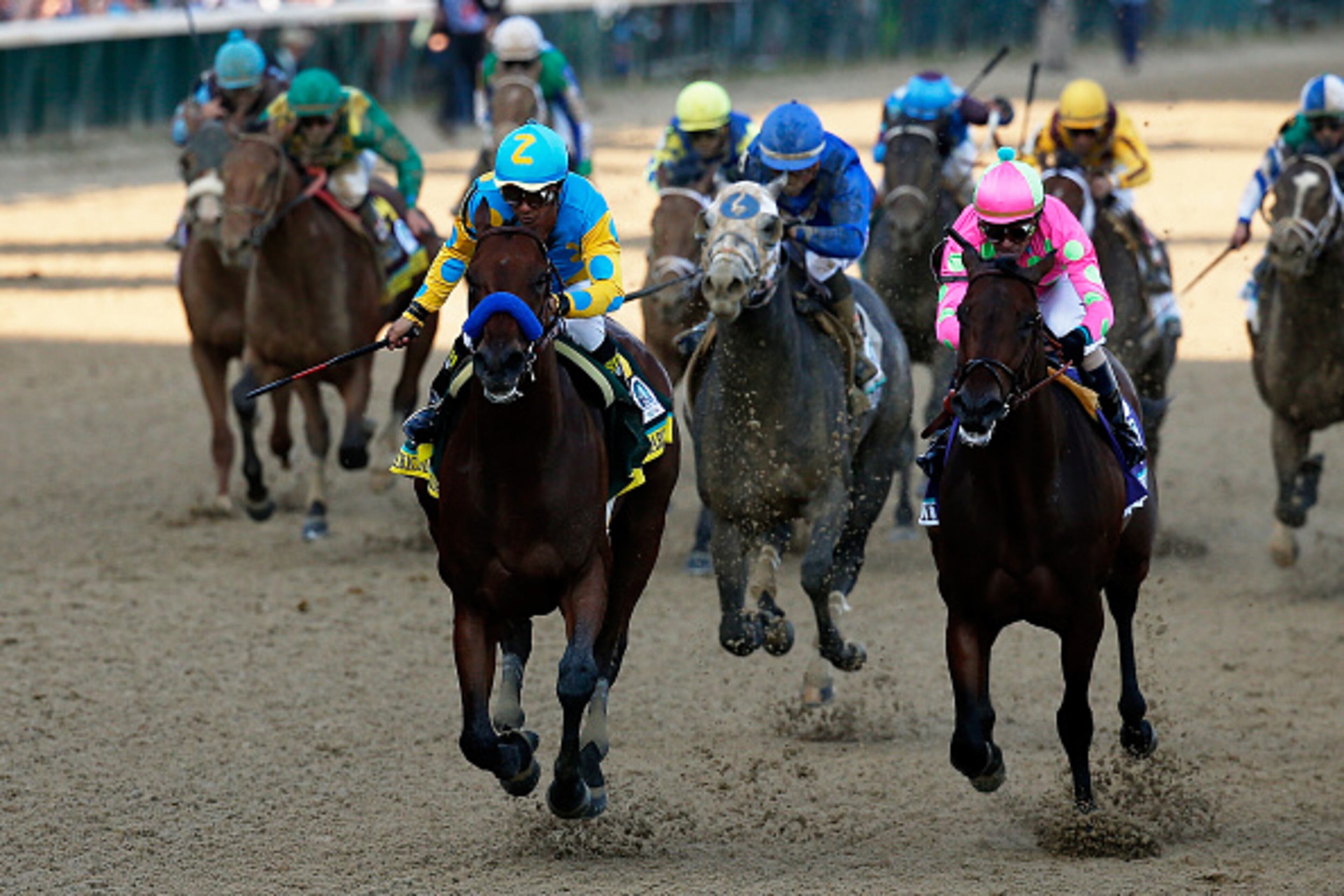 LOUISVILLE, KY - MAY 02: American Pharoah #18, ridden by Victor Espinoza, leads the field to the finish line ahead of Firing Line #10, ridden by Gary Stevens, and Dortmund #8, ridden by Martin Garcia, during the 141st running of the Kentucky Derby at Churchill Downs on May 2, 2015 in Louisville, Kentucky. (Photo by Rob Carr/Getty Images)
