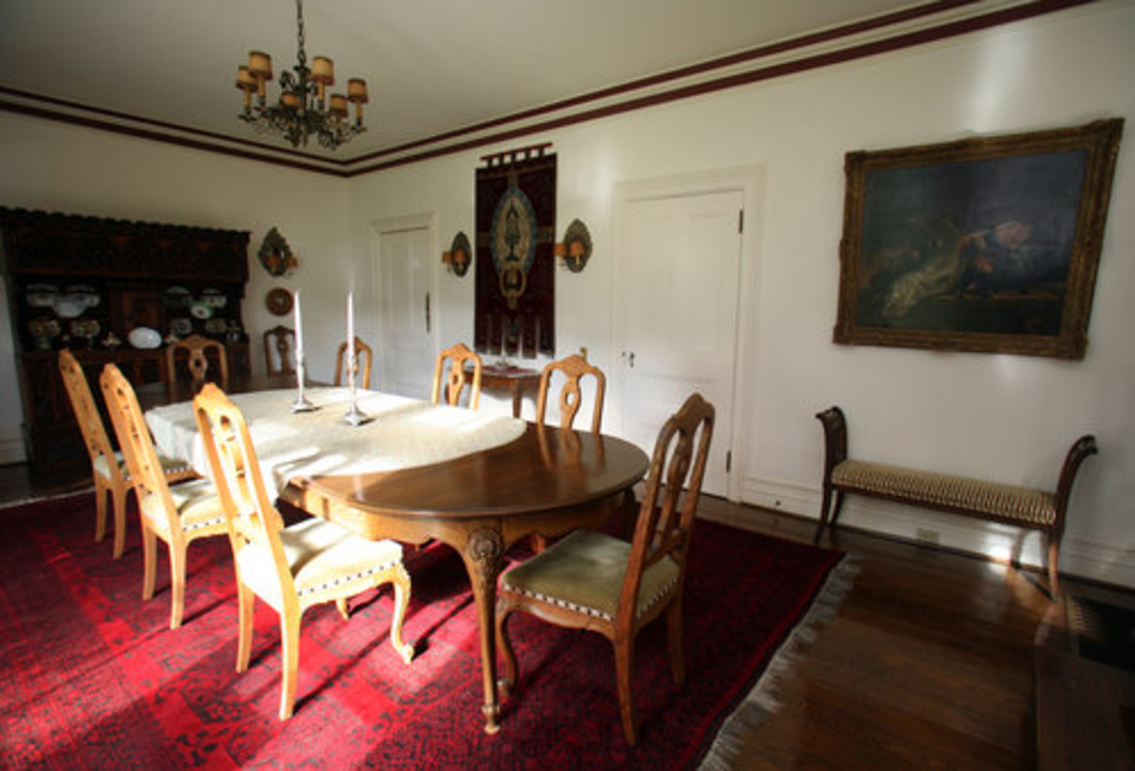 The carved antique sideboard in the dining room is one of the oldest items in the house. Assembled with wooden pegs rather than nails, it dates to the 1500s.