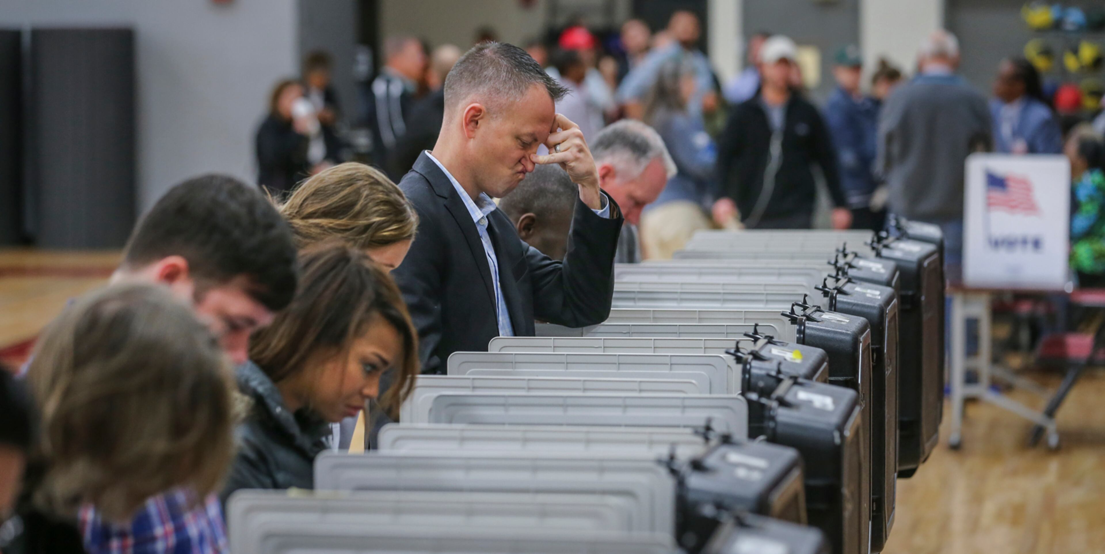 November 8, 2016 Atlanta: Aaron Coe had a disgruntled expression on his face as he voted on Tuesday, Nov. 8, 2016 at Henry W. Grady High School at 929 Charles Allen Dr NE in Atlanta. ÒIÕm pleased to say all the polls opened on time and on schedule," Fulton elections director Richard Barron told The AJC. "WeÕre expecting 70 percent turnout."ÊÊThe previous early voting record in 2012 was 152,562. When absentee ballots come in, Barron said he expects the early vote will be about 284,000.ÊÊÒItÕs a major accomplishment for us," he said. "Early voting worked in our favor. WeÕre pleased that our residents listened.ÊÊOur hope is that todayÕs voters also will be patient if they have a wait.Ó AÊrecord 2.38 million peopleÊcast their ballots during the stateÕs early voting period, which ended Friday. Local officials enacted safety plans to make sure all went smoothly Tuesday. Deputies were assigned to busier polling sites in Cobb County, and deputies drove by polling spots in Gwinnett County, Channel 2 Action News reported. Fulton County police didnÕt assign special patrols, but police said officers monitored polls. JOHN SPINK /JSPINK@AJC.COM