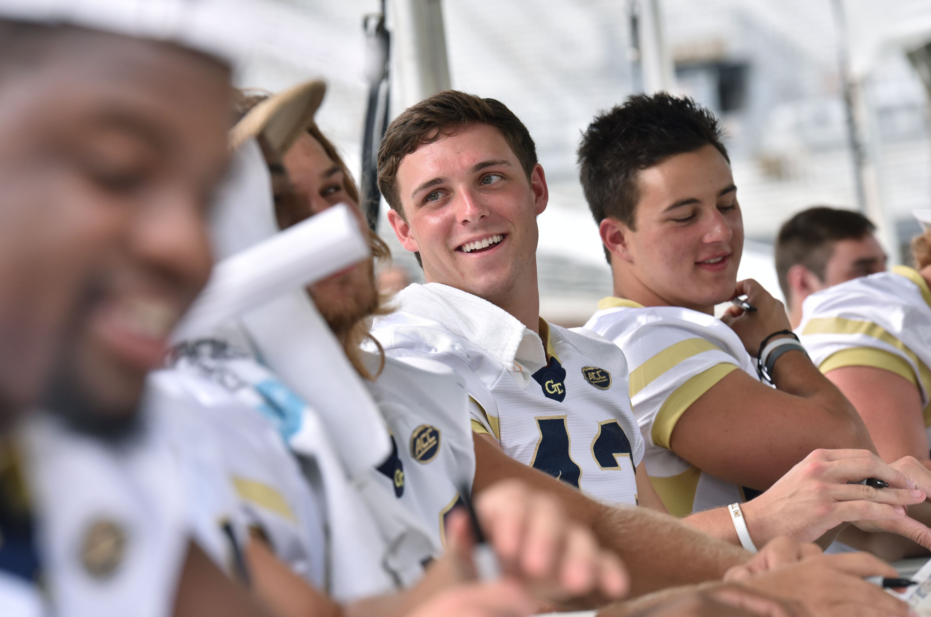 Georgia Tech Yellow Jackets linebacker Tyler Cooksey (center) and other linebackers sign autographs for fans during 2016 Football Fan Day at Bobby Dodd Stadium on Saturday, August 6, 2016. HYOSUB SHIN / HSHIN@AJC.COM