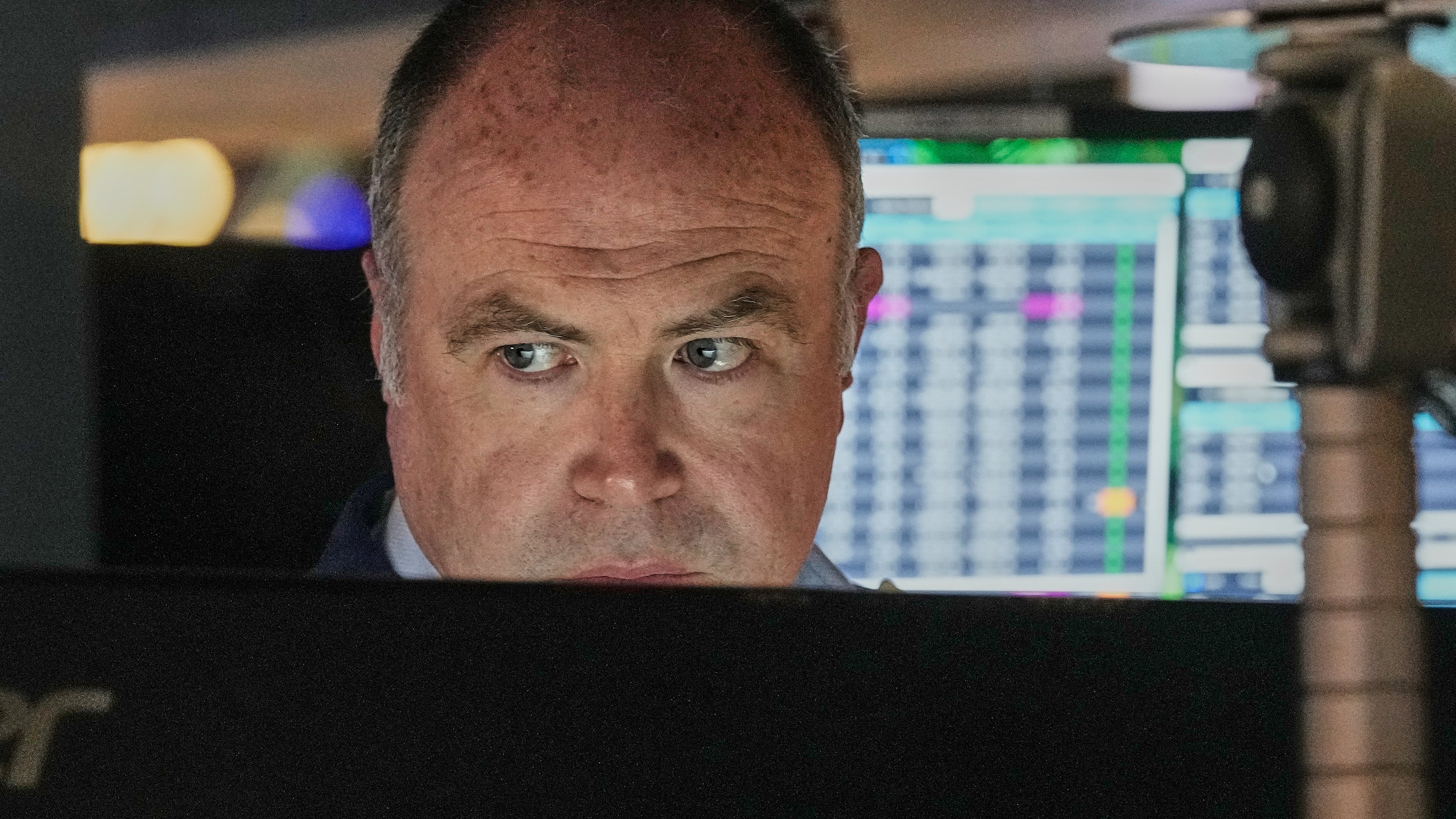 Trader Derek Orth works on the floor of the New York Stock Exchange, Thursday, April 30, 2026. (AP Photo/Richard Drew)