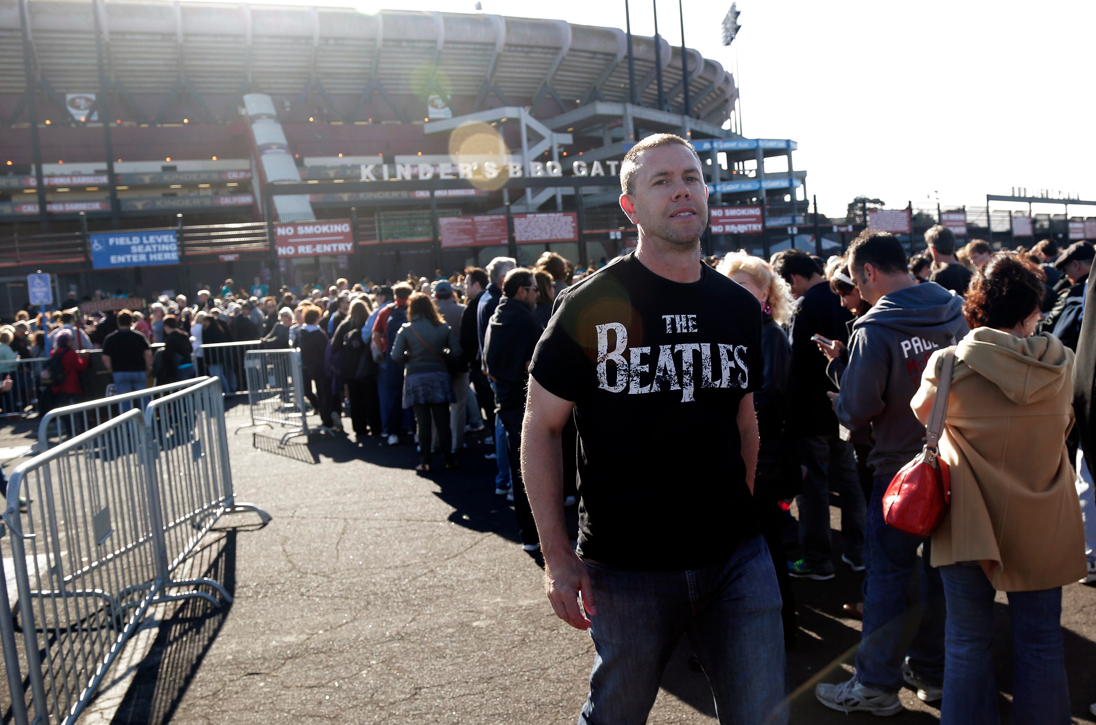 Fans line up outside Candlestick Park before a Paul McCartney concert Thursday, Aug. 14, 2014, in San Francisco. San Francisco is saying goodbye to the stadium where its beloved Giants and 49ers celebrated some of their greatest triumphs. (AP Photo/Marcio Jose Sanchez)