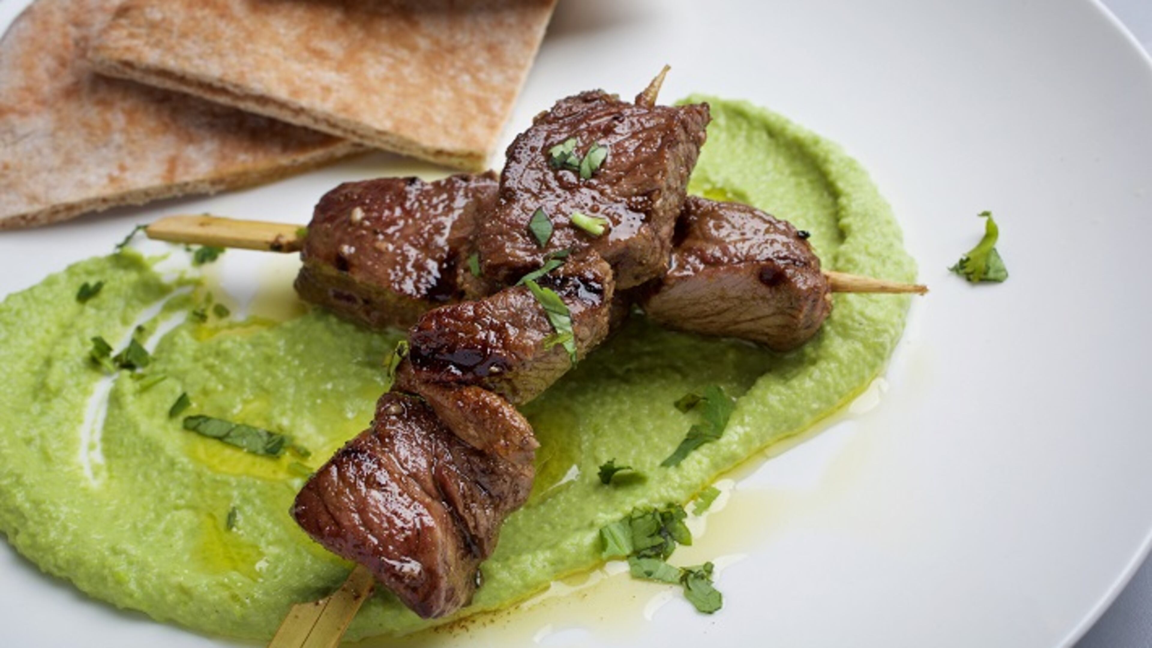 Pea Hummus With Grilled Marinated Lamb. MUST CREDIT: Photo by Deb Lindsey for The Washington Post.
