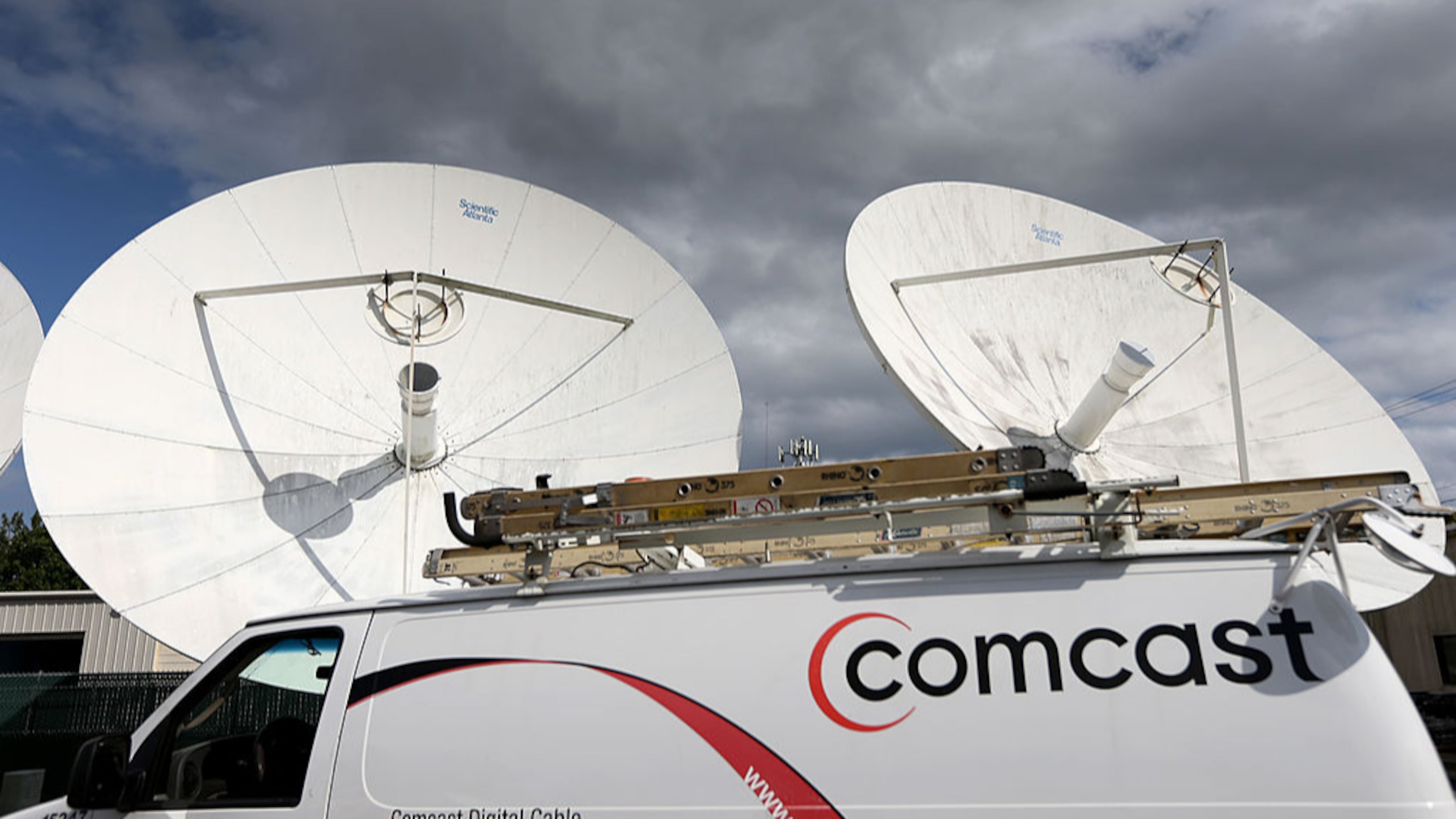 A Comcast truck is parked at one of the cable giant’s centers in Pompano Beach, Florida. The company announced it’s launching a new service, Xfinity Mobile.