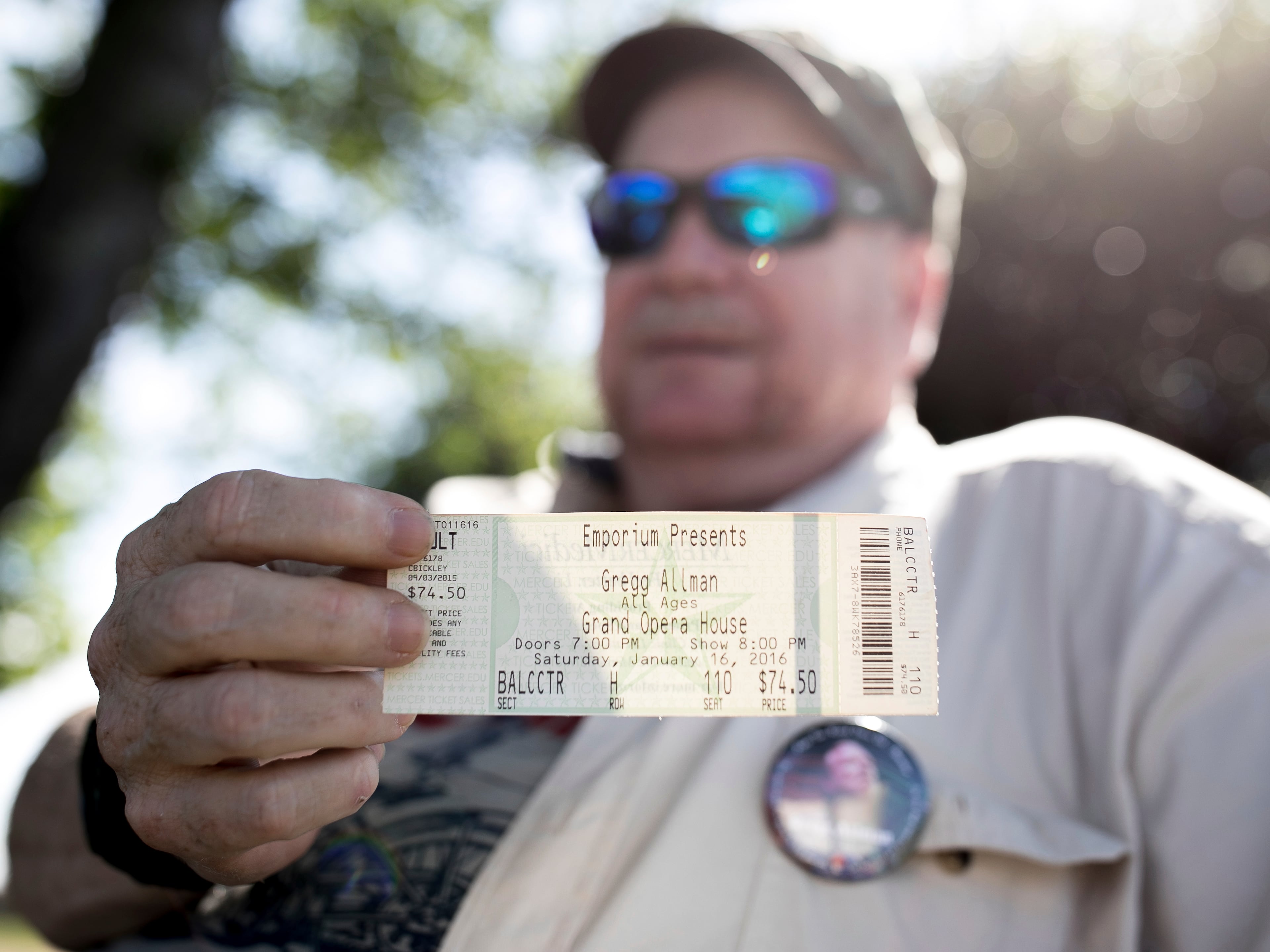 Mark Elliott shows a concert ticket from the last Gregg Allman concert he attended, Saturday, June 3, 2017, in Macon, Ga. Family, friends and fans on Saturday will say goodbye to the music legend, who died over the Memorial Day weekend at the age of 69. (AP Photo/Branden Camp)