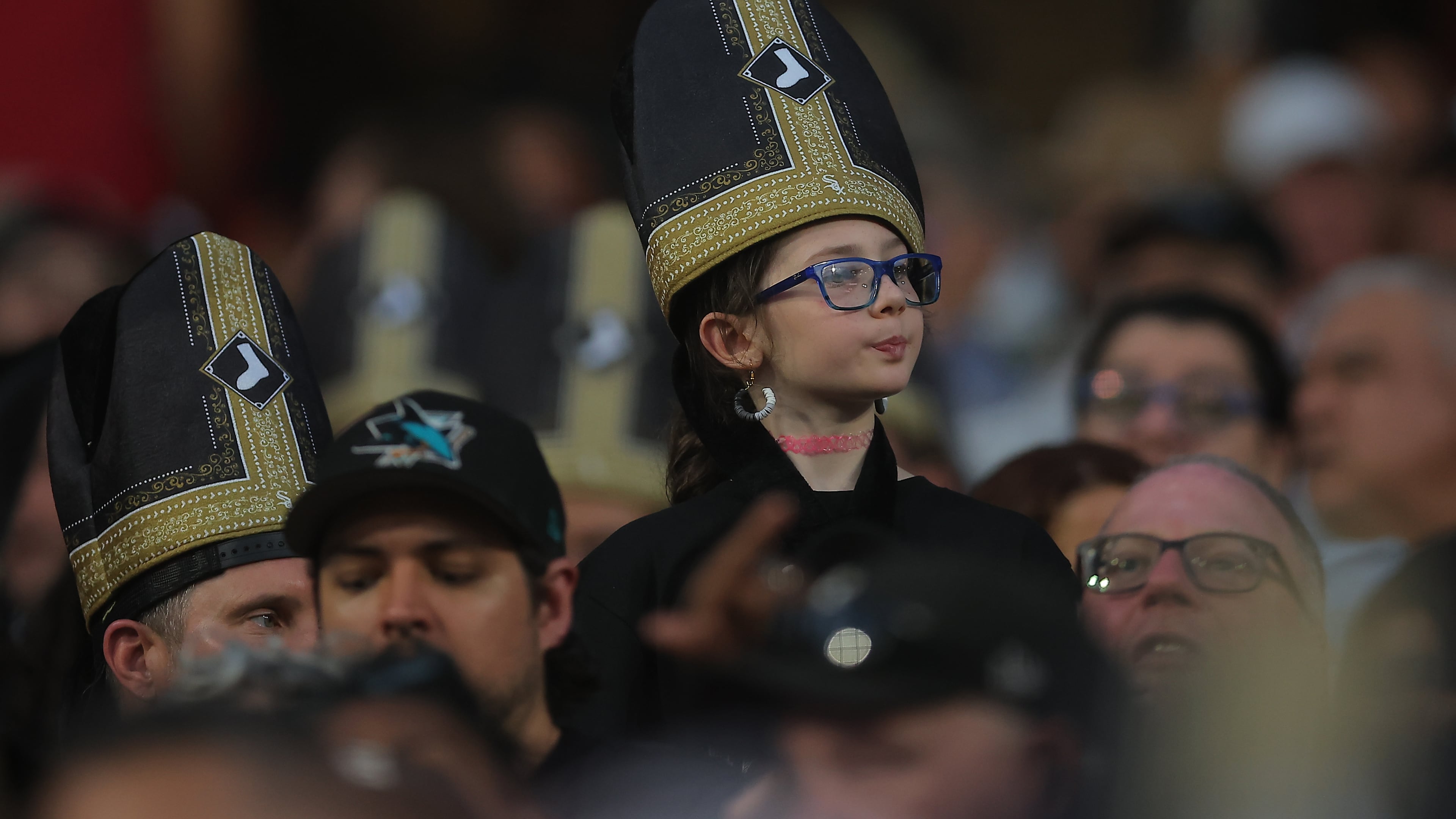 A fan wears a promotional pope hat during a baseball game between the Cincinnati Reds and Chicago White Sox, Tuesday, Aug. 11, 2026, in Chicago. (AP Photo/Melissa Tamez)