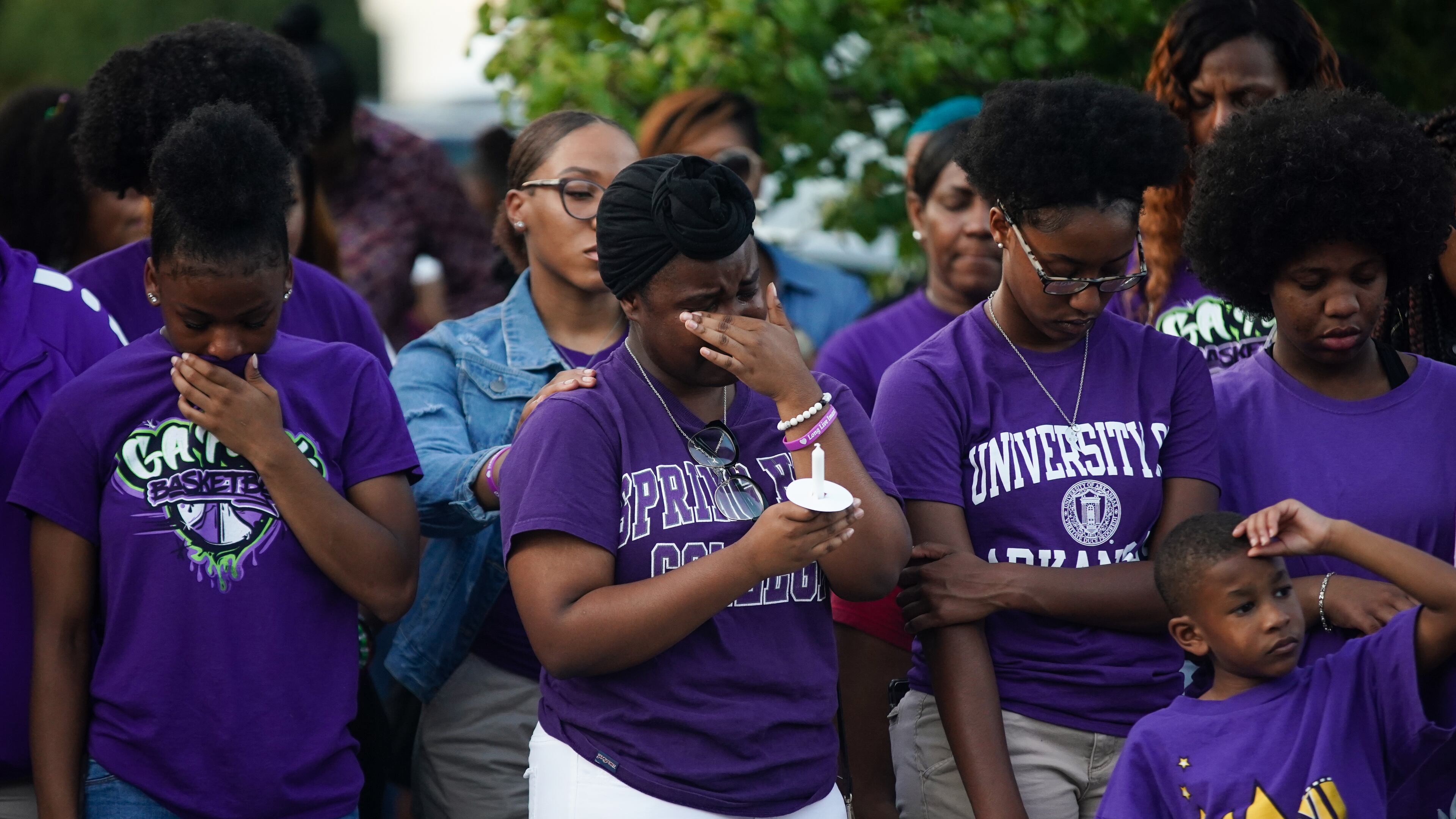 Friends and teammates of Imani Bell become emotional while participating in a candlelight vigil for her Aug. 21 in Jonesboro.