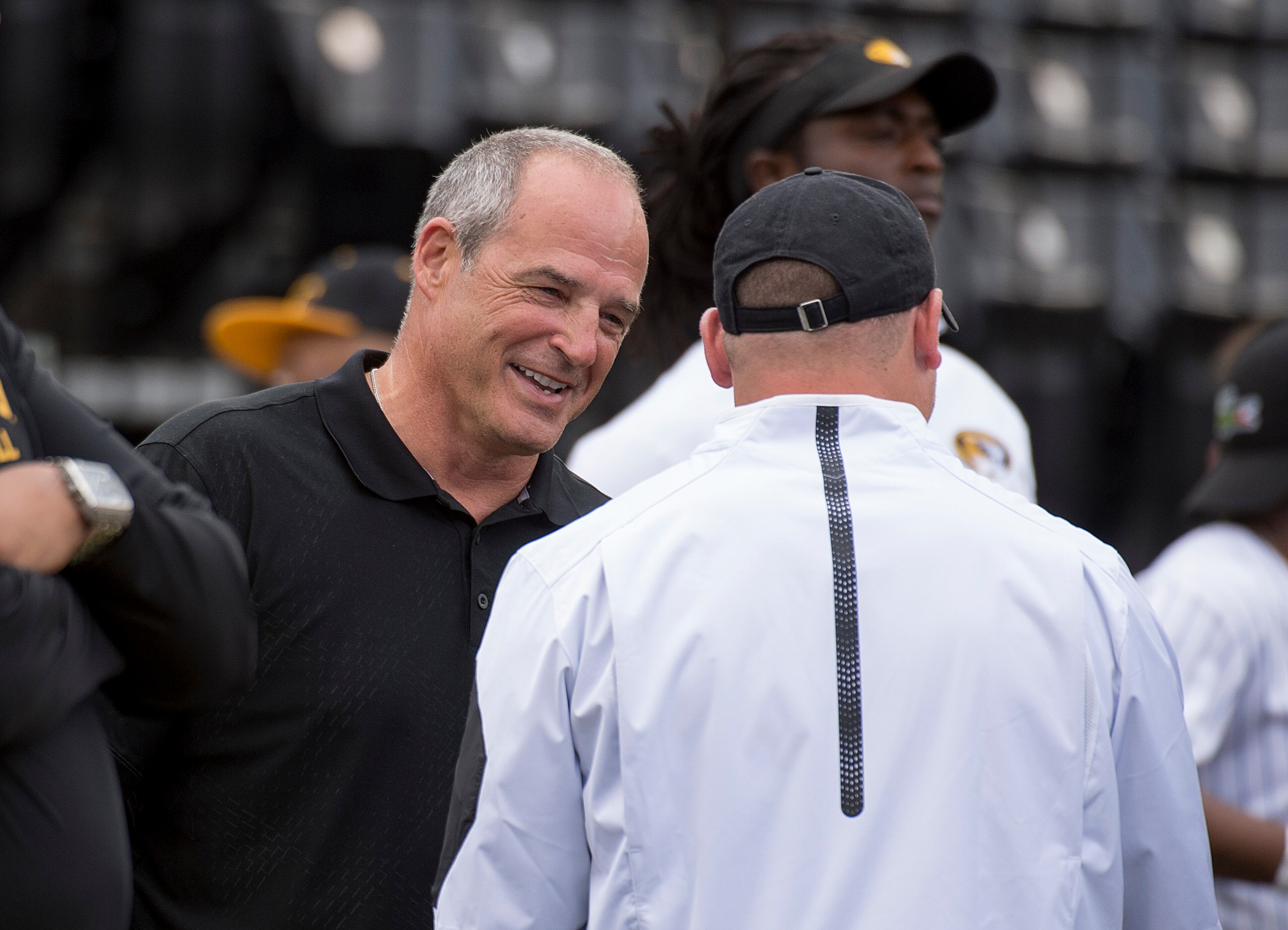 Former Missouri head coach Gary Pinkel, left, talks with the team's current coach, Barry Odom, before the NCAA college football team's spring game Saturday, April 16, 2016, in Columbia, Mo. (AP Photo/L.G. Patterson)