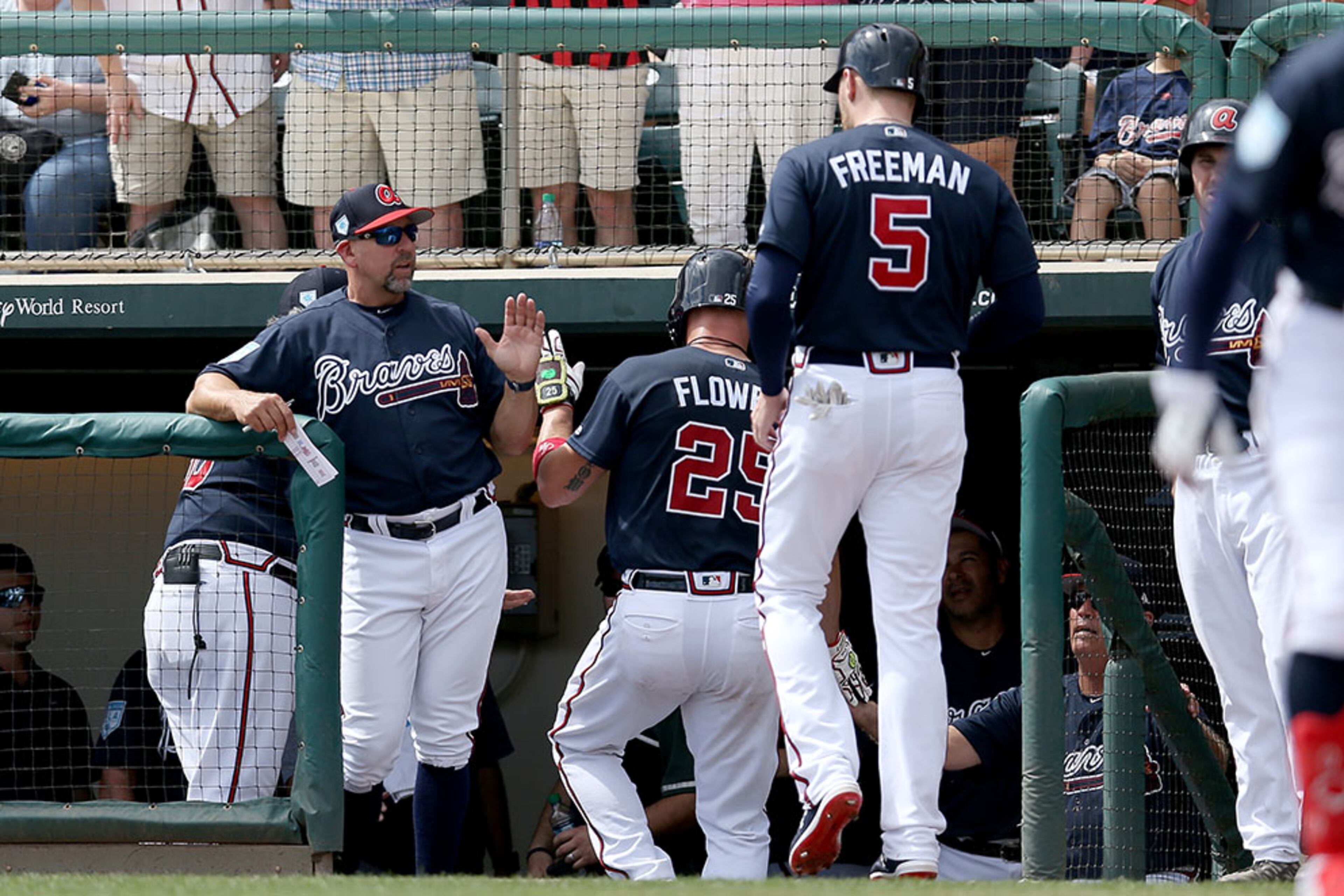 Braves Manager Brian Snitker celebrates with Tyler Flowers (25) and Freddie Freeman (5) after Flowers hit a home run in the first inning Sunday, March 3, 2019, against the Miami Marlins at Champion Stadium in Lake Buena Vista, Fla.