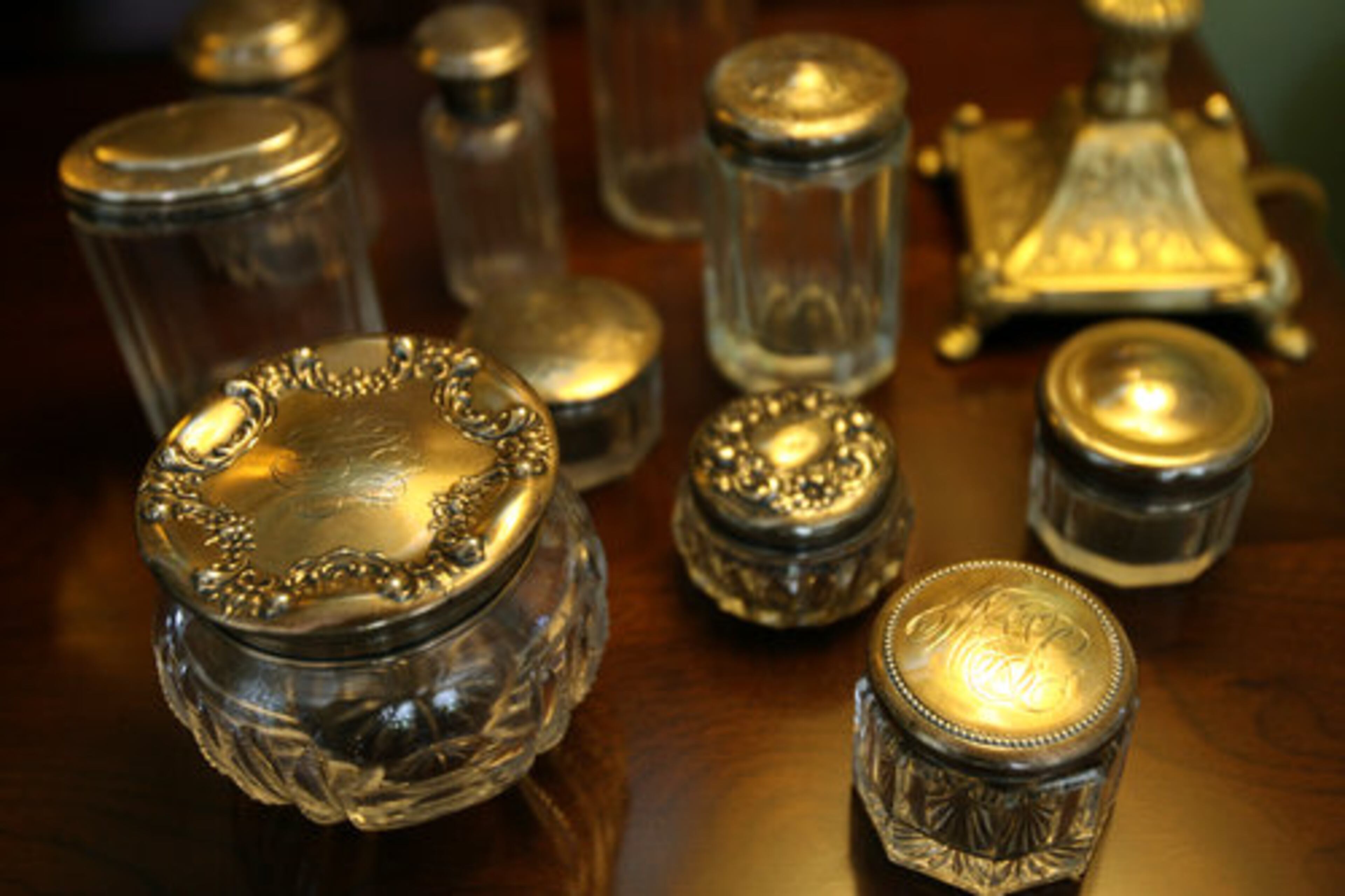 Small glass monogrammed jars line a table in the dining room.