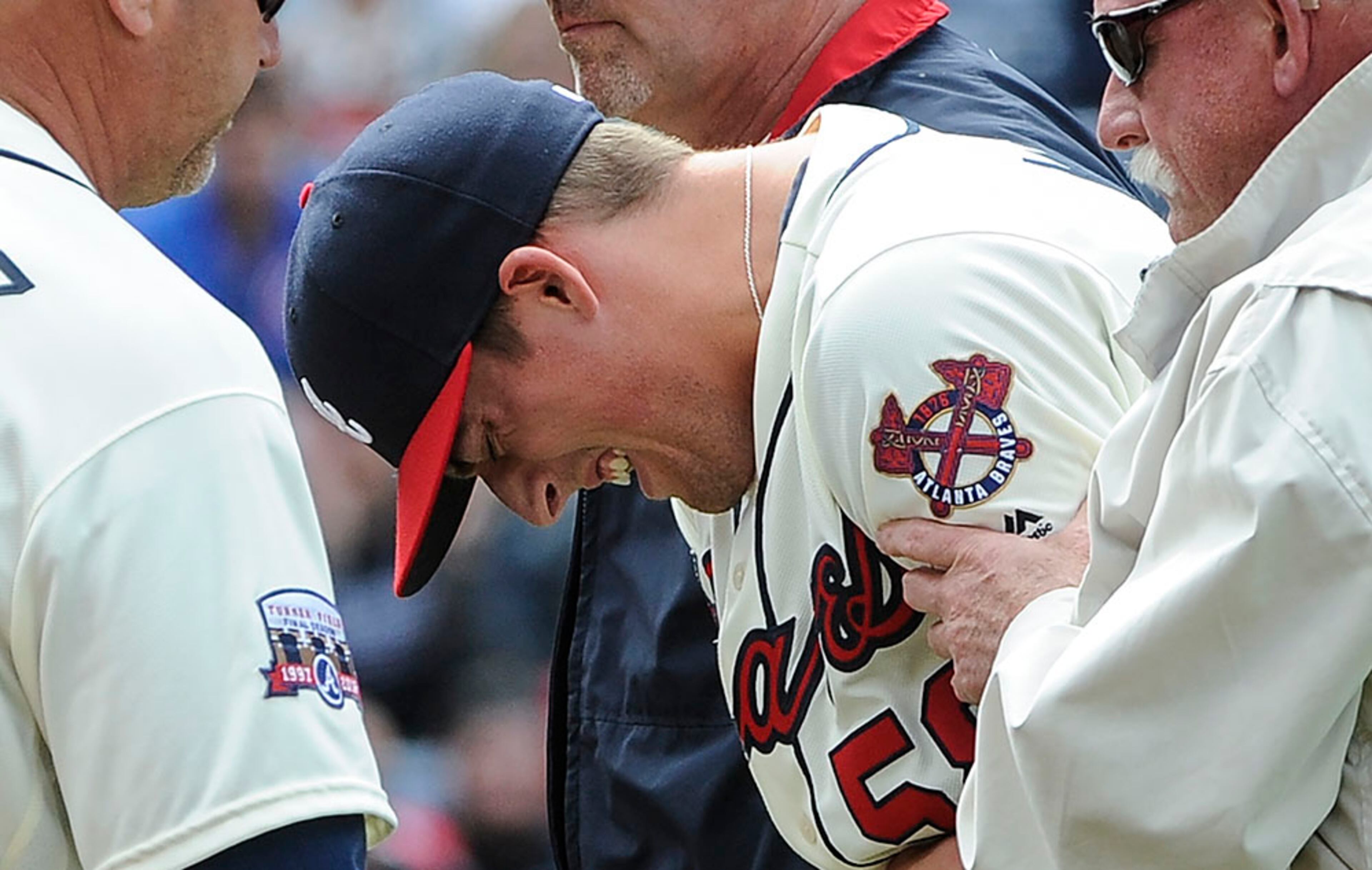 Braves right-hander Dan Winkler is helped off the field after appearing to suffer an injury to his throwing arm during the seventh inning against the Cardinals Sunday, April 10, 2016, at Turner Field in Atlanta.