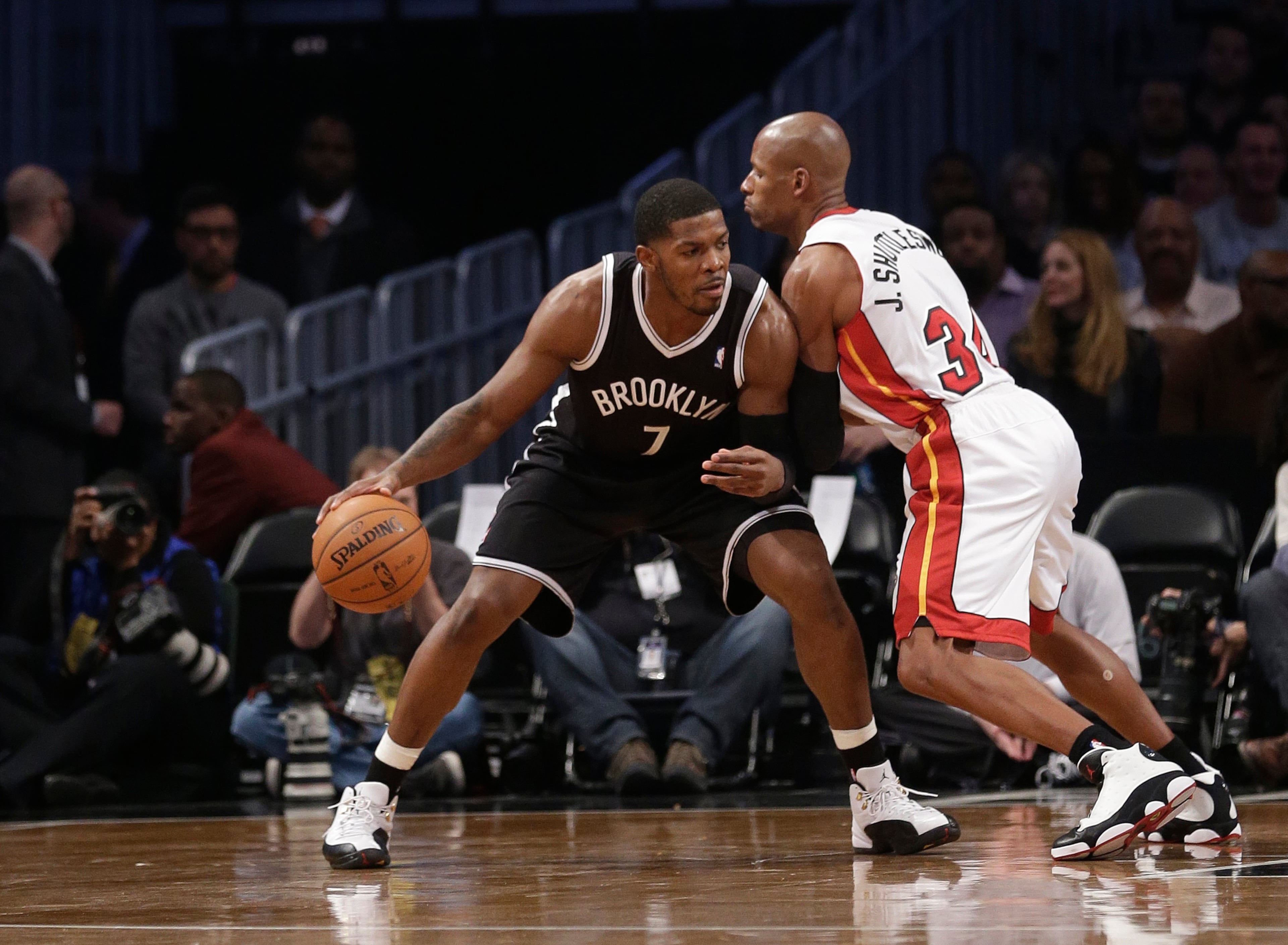 Brooklyn Nets' Joe Johnson (7) is defended by Miami Heat's Ray Allen (34) during the first half of an NBA basketball game on Friday, Jan. 10, 2014, in New York.