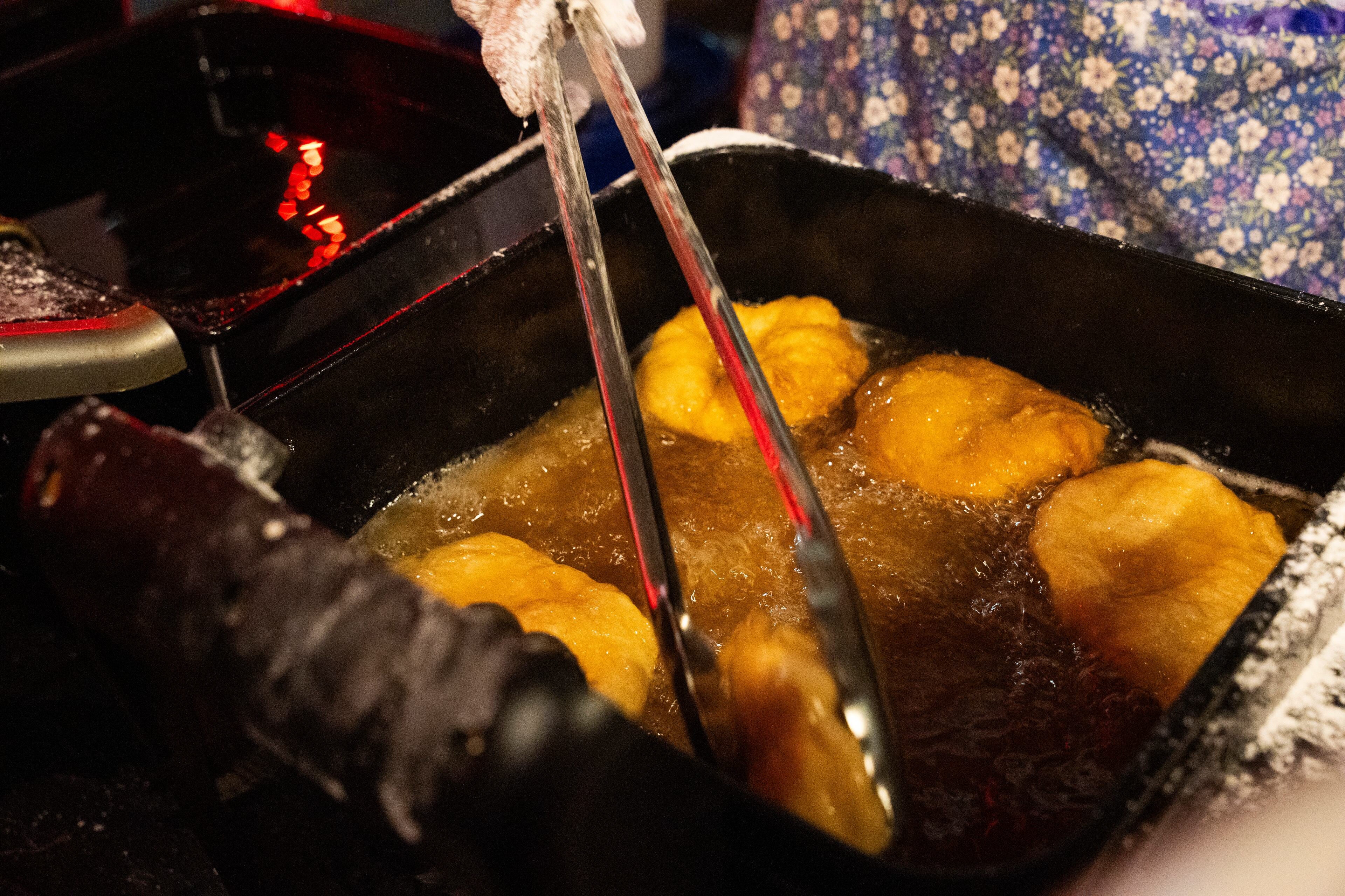Vendors make traditional frybread topped with venison, beans and shredded cheese at the "Art of Activism" at 7 Stages Theatre in Atlanta on Friday, Nov. 14, 2025. This event marks the beginning of several weekends of festivities for the First Voices Festival, a celebration of Indigenous cultures (Olivia Bowdoin for the AJC)