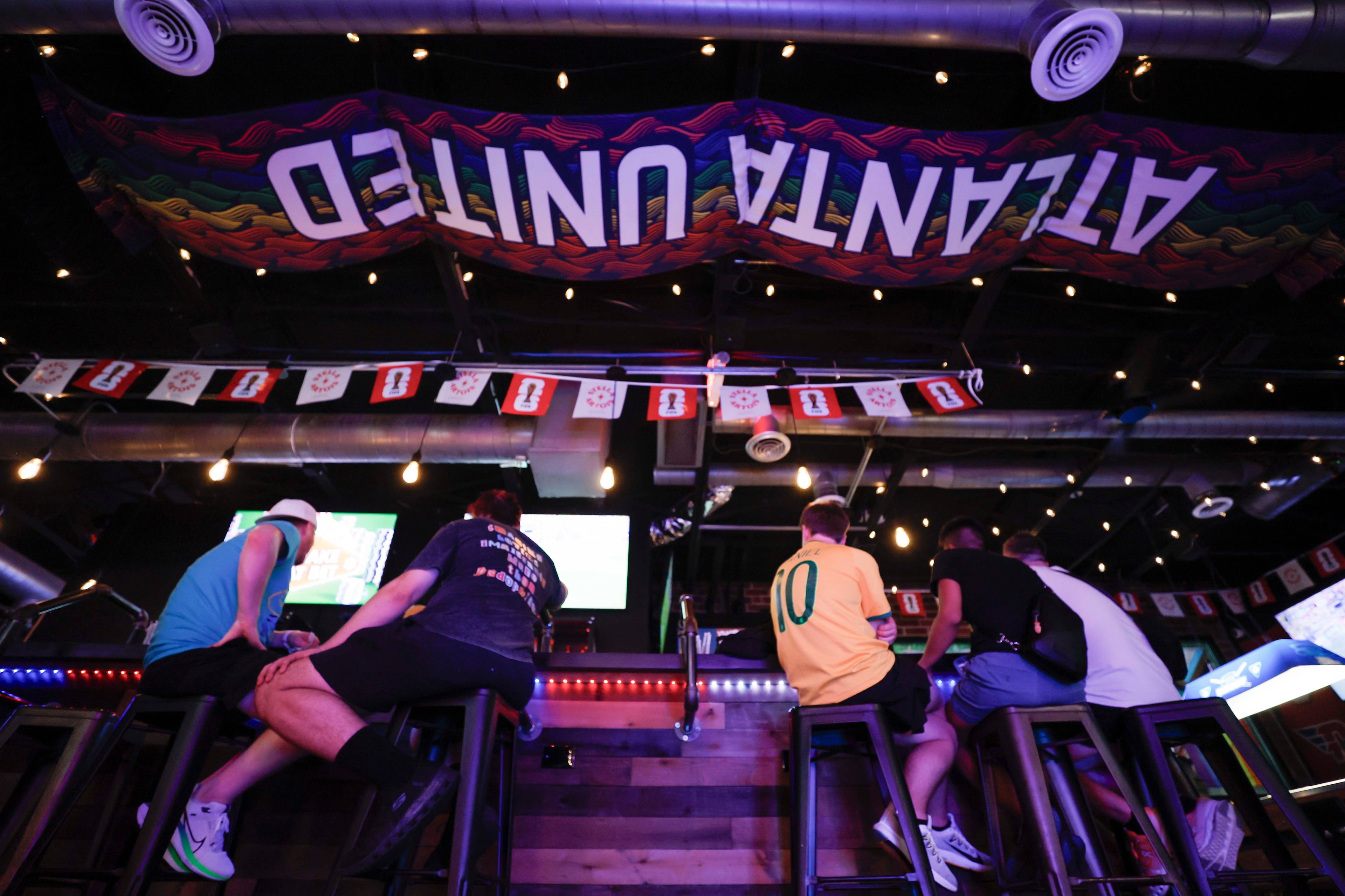 Patrons are pictured inside the Woofs Sport Bar in Midtown on Sunday, July 5, 2026. (Miguel Martinez/AJC)