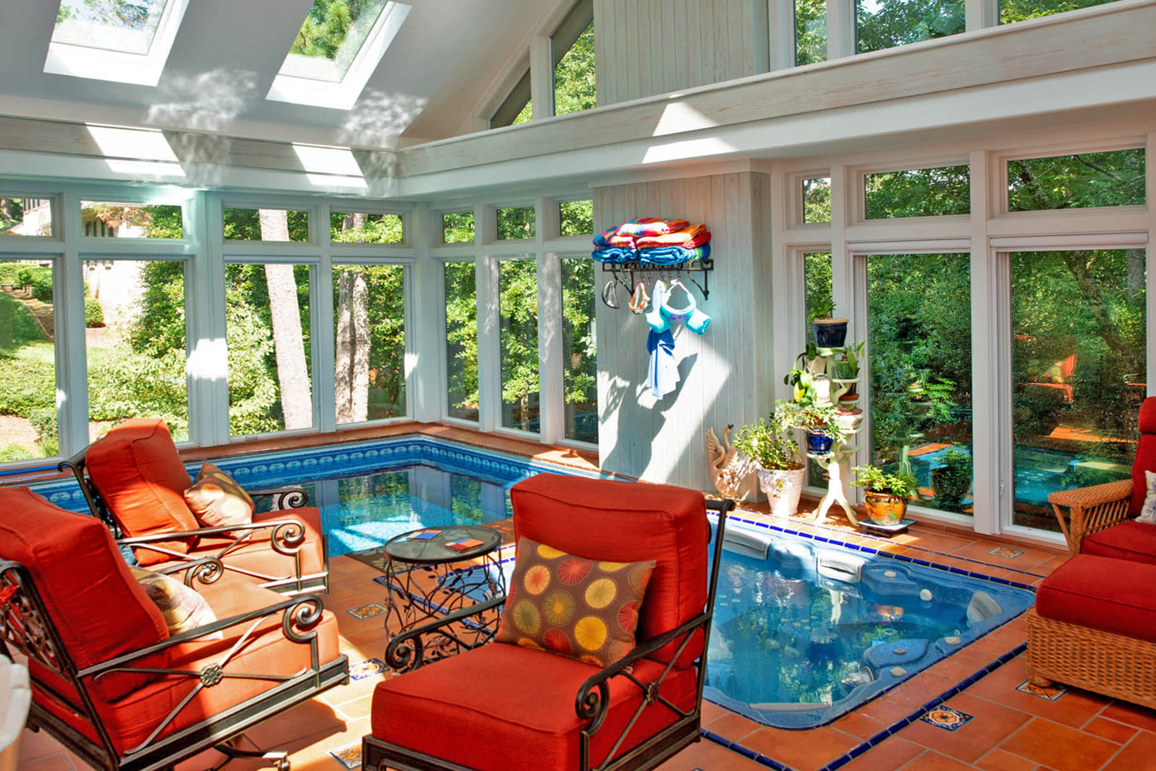 The vaulted sunroom, completed in 2011, includes a pool by Endless Pools. Kauffman Design was the architect and project manager for the sunroom.