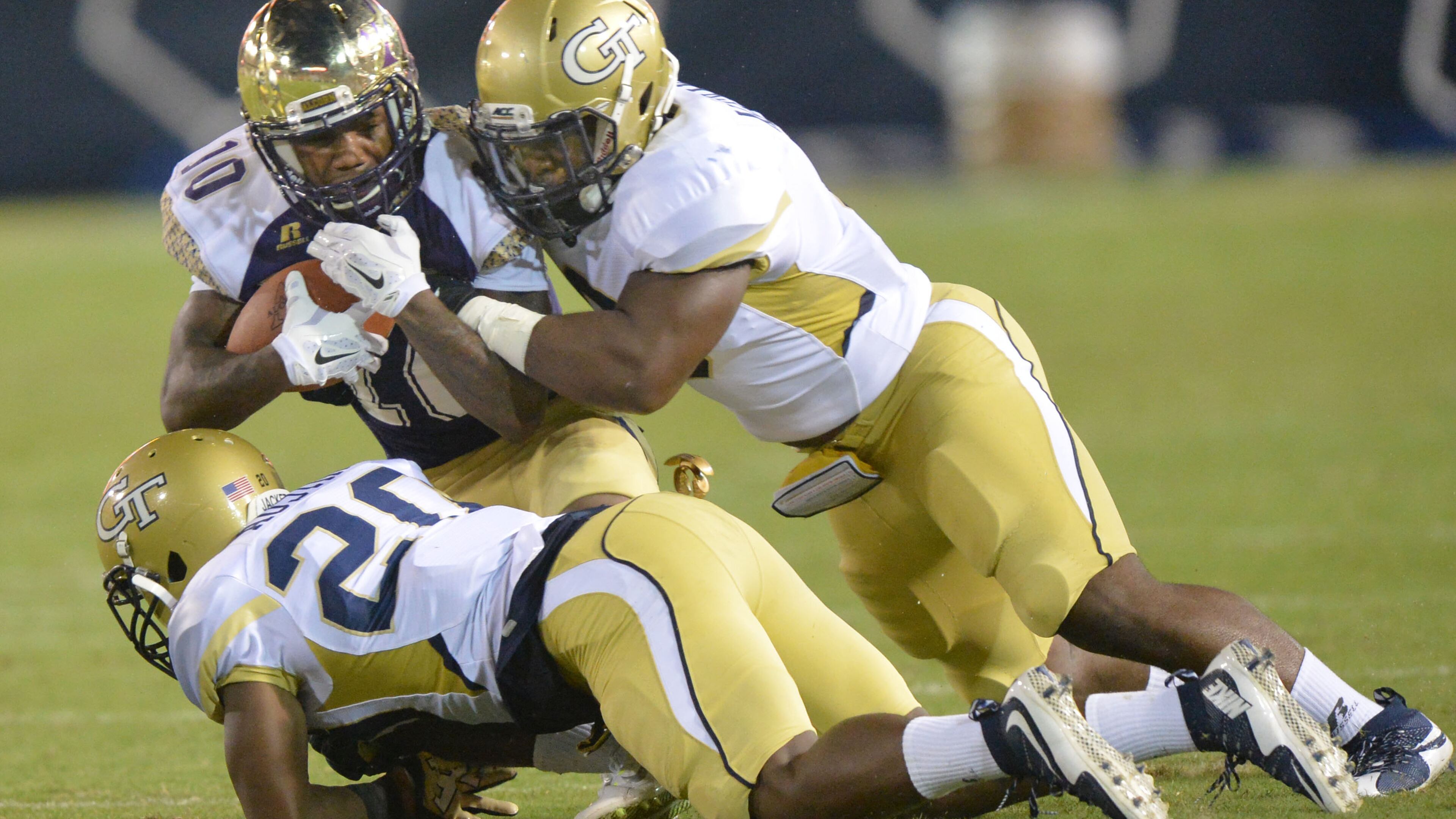 September 3, 2015 Atlanta - Alcorn State Braves wide receiver Marquis Warford (10) gets tackled by Georgia Tech Yellow Jackets defensive back Lawrence Austin (20) and Georgia Tech Yellow Jackets linebacker Victor Alexander (9) in the first half of the Georgia Tech season opener in Bobby Dodd Stadium on Thursday, September 3, 2015. HYOSUB SHIN / HSHIN@AJC.COM