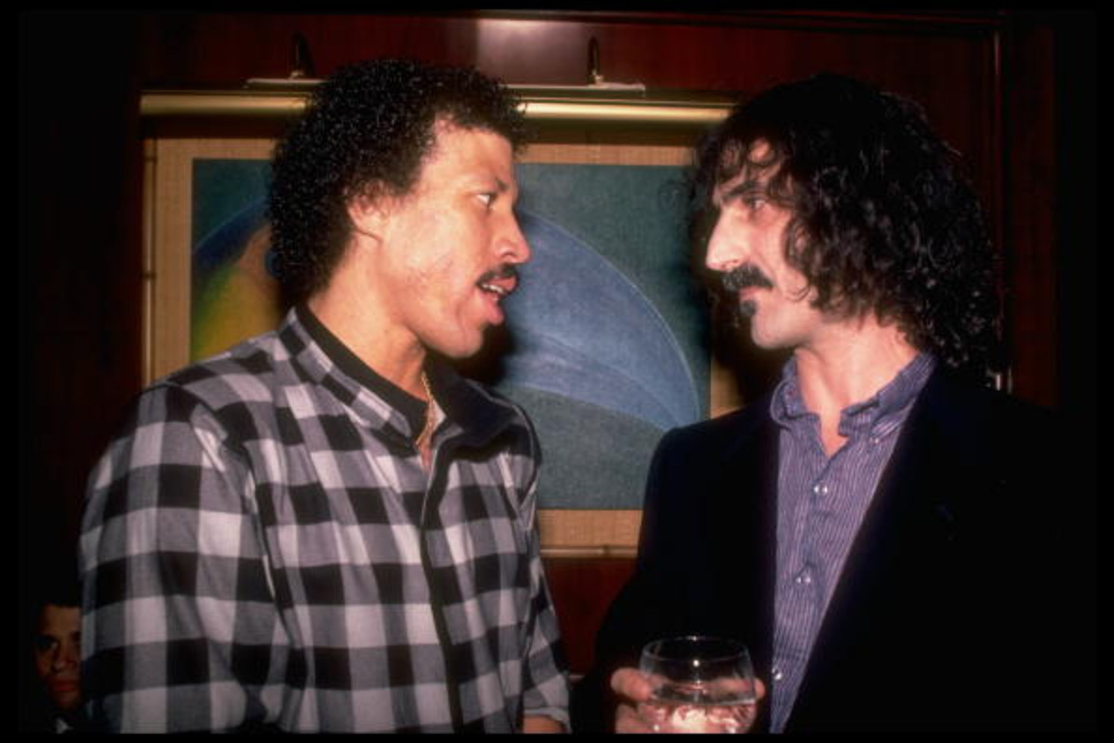 (L-R) Singers Lionel Richie and Frank Zappa. (Photo by Robin Platzer//Time Life Pictures/Getty Images)