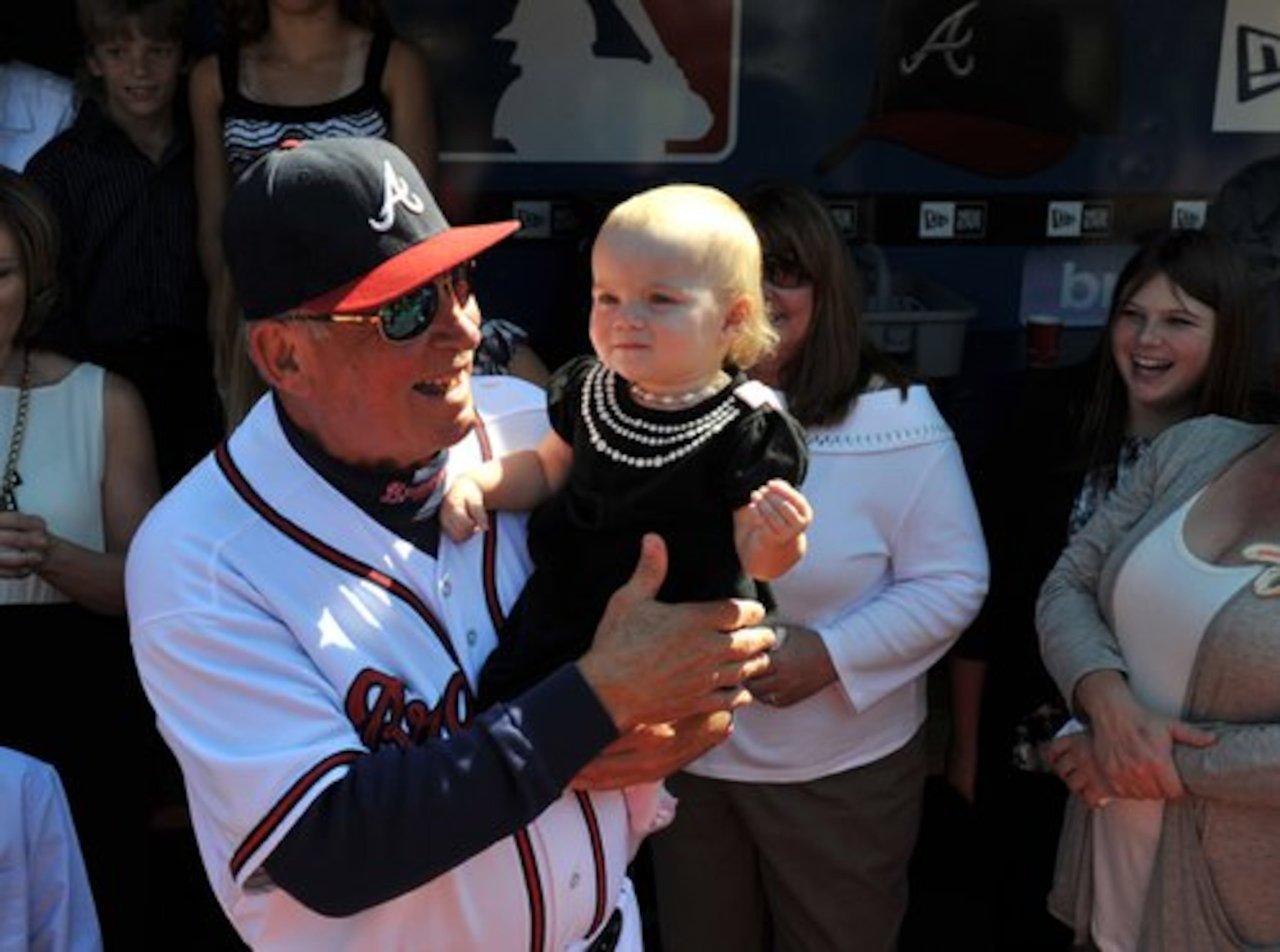 Braves manager Bobby Cox holds his 14-month-old granddaughter, Seda Lindsay, as he makes his way onto the field for pre-game tribute Saturday, Oct. 2, 2010. Photos by Brant Sanderlin.