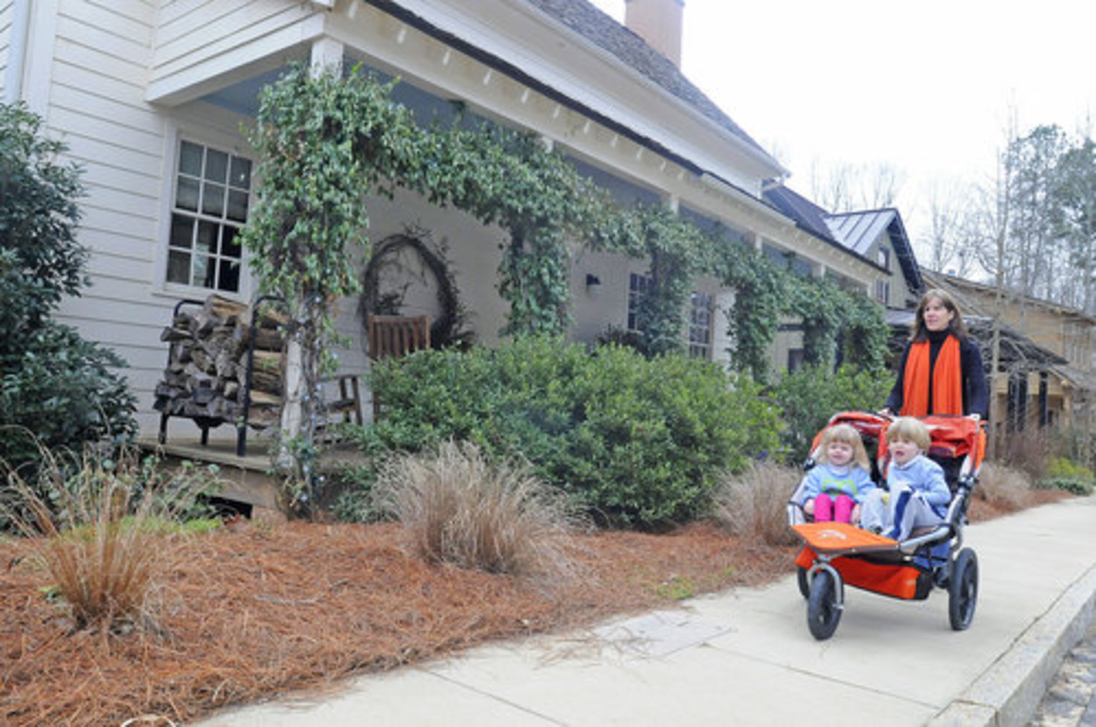 Susan Isakson takes her children out for a stroll in her Serenbe neighborhood.
