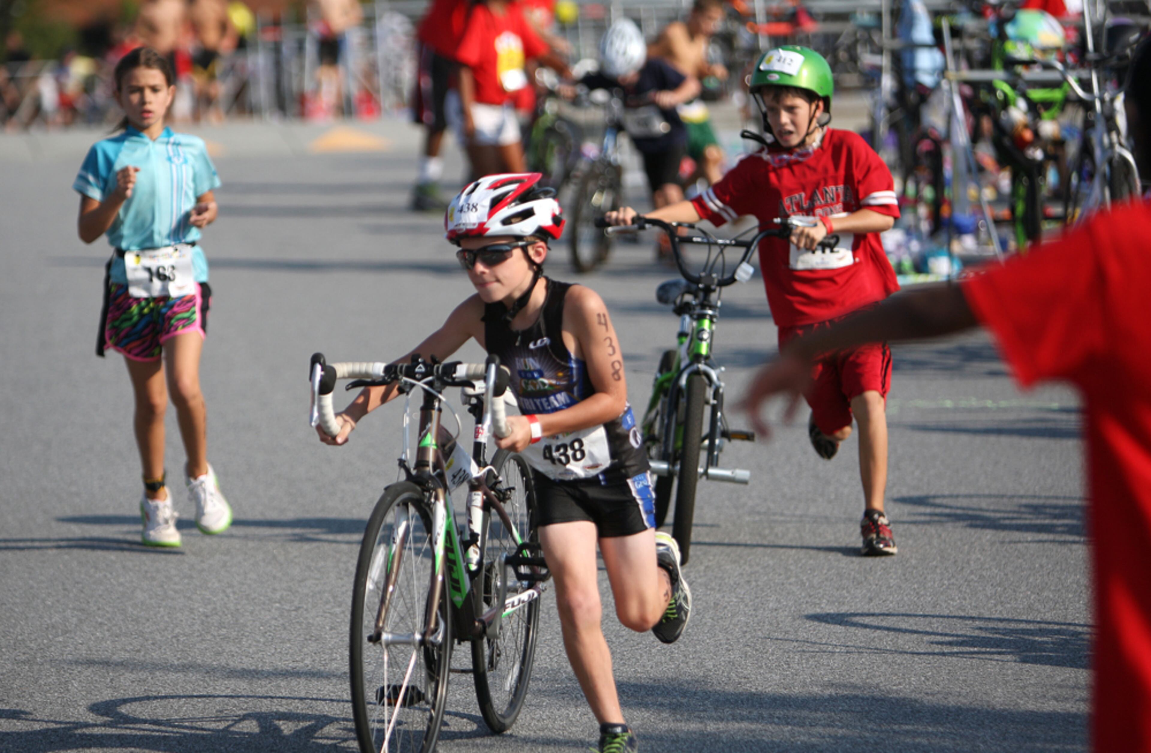 KIDS TRIATHLON--Over 800 kids participated in the Atlanta Kids Triathlon, consisting of swimming, biking and running at West Gwinnett Aquatic Center Sunday August 26, 2012. Kids race against other kids in their same age group. For Juniors ages 6-10: Swim is 100 meters, Bike is 3 miles, and the Run is 1/2 mile. The event is organized through the Strong Kids Program of the YMCA.