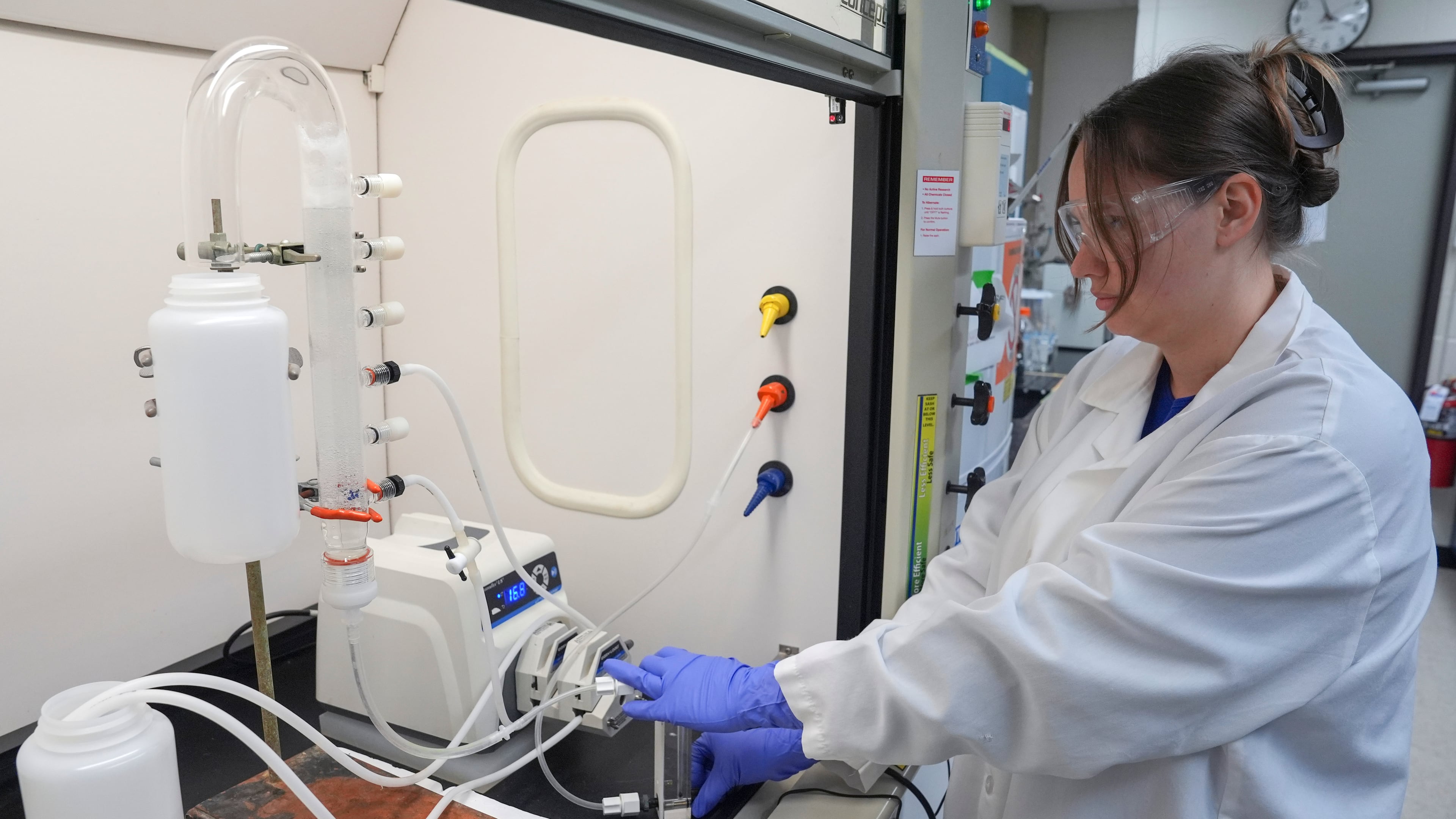 FILE - Stephanie Stoll starts a pump as part of an experiment studying the removal of PFAS from water samples, April 10, 2024, at a U.S. Environmental Protection Agency lab in Cincinnati. (AP Photo/Joshua A. Bickel, File)