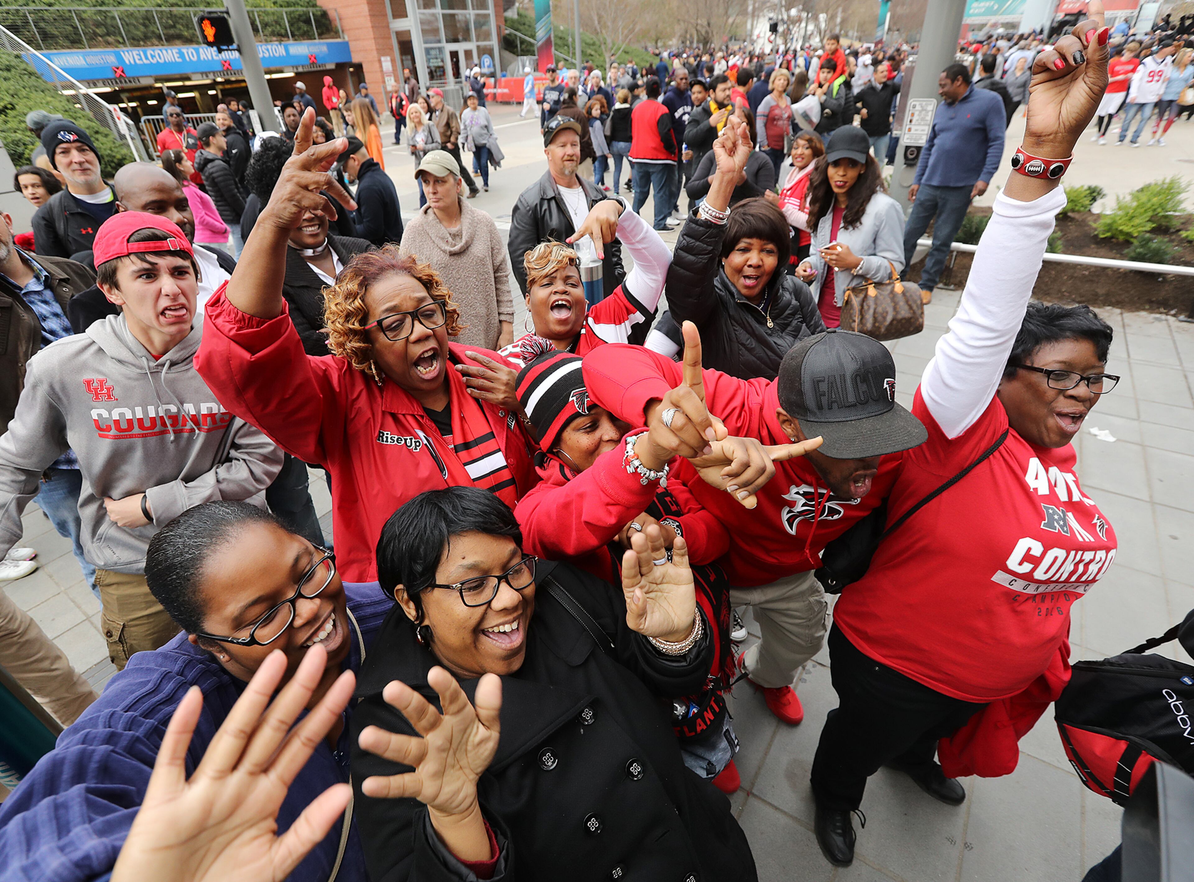 February 4, 2017, Houston: A group of Falcons fans from Atlanta get rowdy the night before the Super Bowl during a visit to the NFL Experience and Super Bowl Live on Saturday Feb. 4, 2017, in Houston. Curtis Compton/ccompton@ajc.com