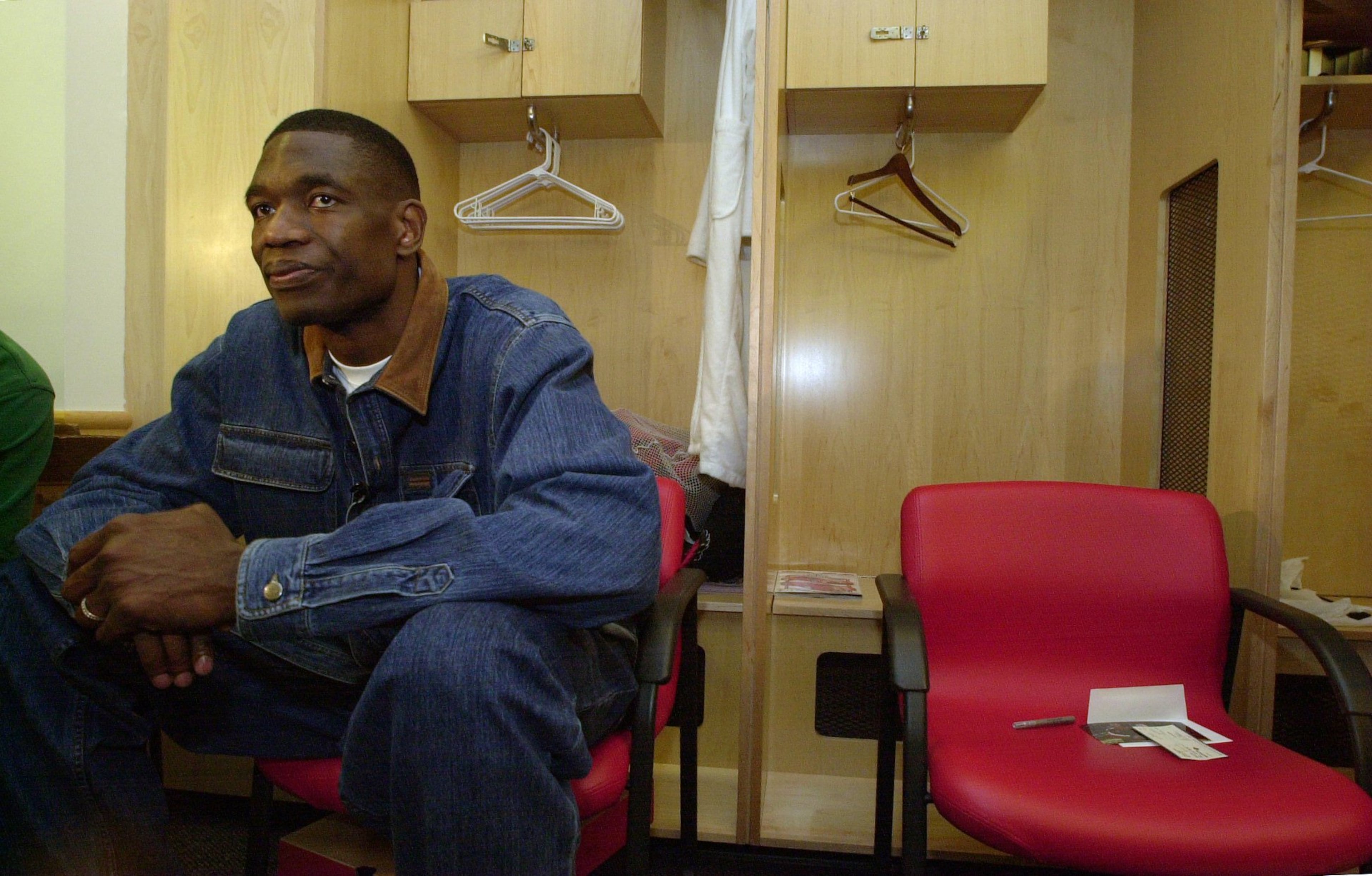 Sitting in front of his empty locker, Hawks' player Dikembe Mutombo reflects on his team's disappointing season Thursday 4/20/00. Mutombo is working in the off season to build a hospital in his home country. (DAVID TULIS/Staff)