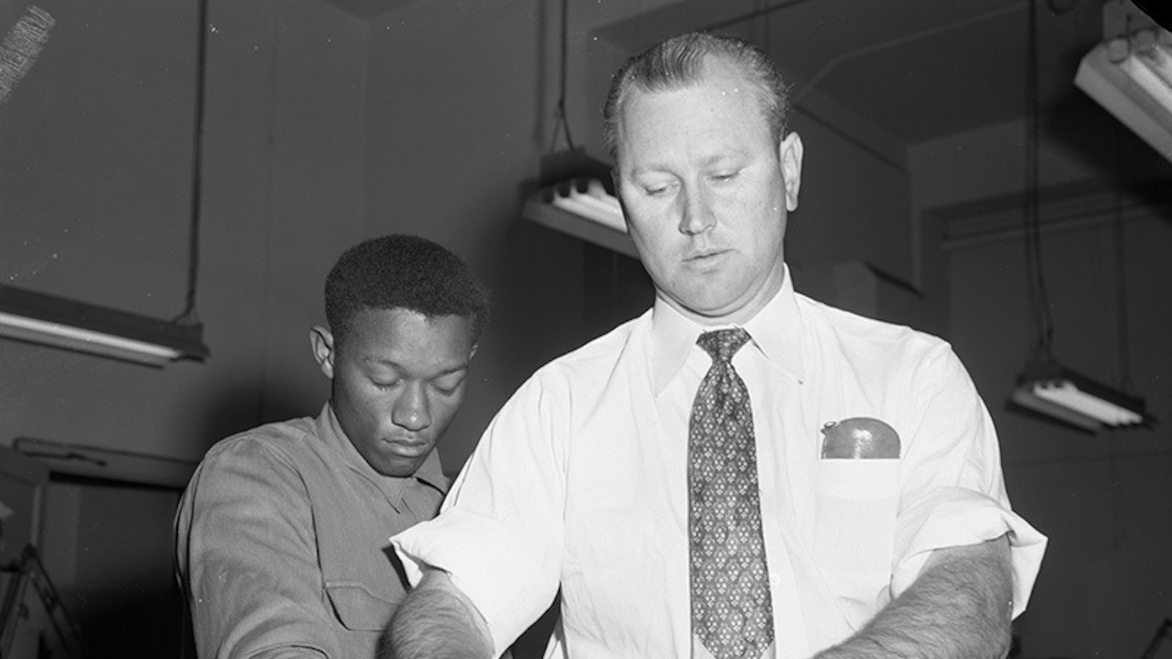 In this photo provided by the Dallas History & Archives Division, Dallas Public Library, Tommy Lee Walker, a Black man from Texas, is fingerprinted after his arrest in January 1954, for the rape and murder of Venice Parker, a white woman. (Dallas History & Archives Division, Dallas Public Library via AP)