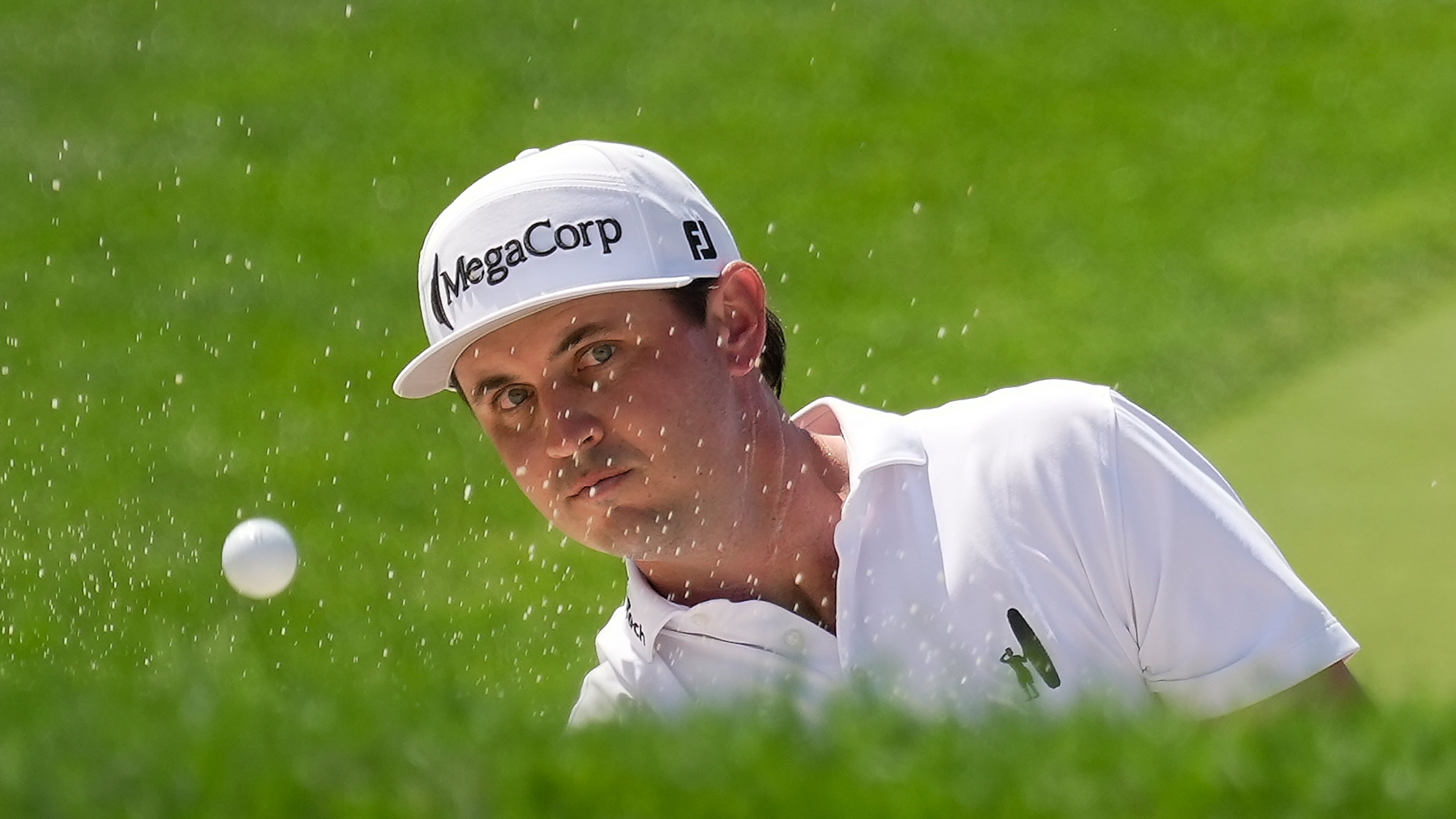 J.T. Poston hits from a bunker to the 18th green during the second round of the Memorial golf tournament in Dublin, Ohio, Friday, June 5, 2026. (AP Photo/Sue Ogrocki)