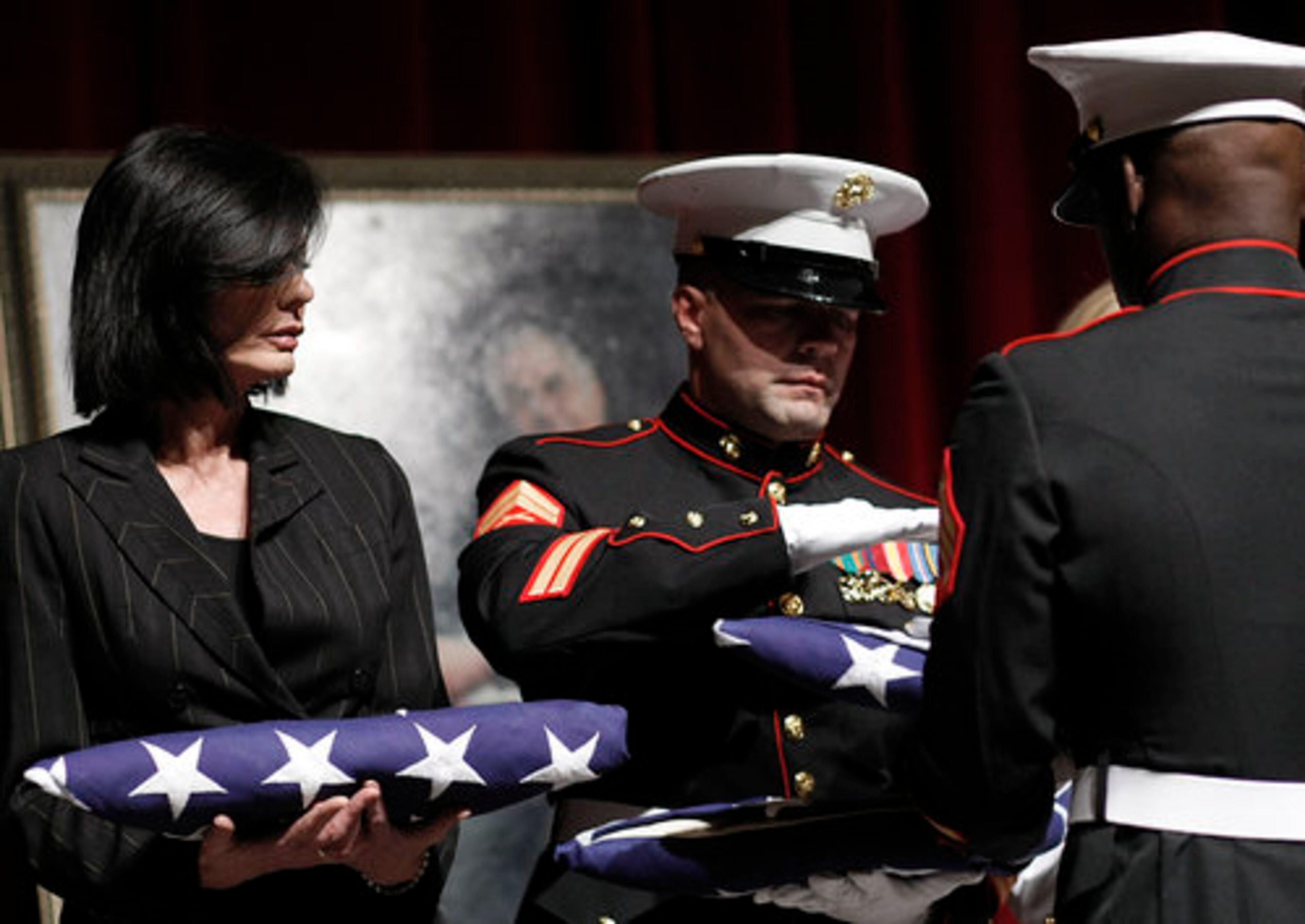 Lex McMahon, right, son of the late television personality Ed McMahon, and Pam McMahon, McMahon's wife, receive flags. Before the tribute, Pam McMahon choked back tears as she spoke about her husband. She stayed by his side during the five months he was hospitalized before his death. "He really was one of the most wonderful men I ever met in my entire life," she said.