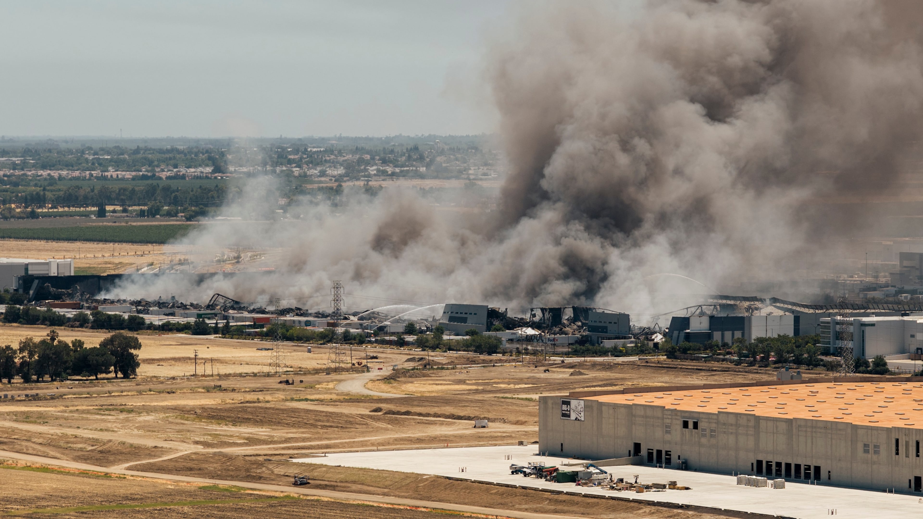 Smoke is seen from the massive fire at the Medline medical supply warehouse in Tracy, Calif., Friday, June 12, 2026. (Stephen Lam/San Francisco Chronicle via AP)