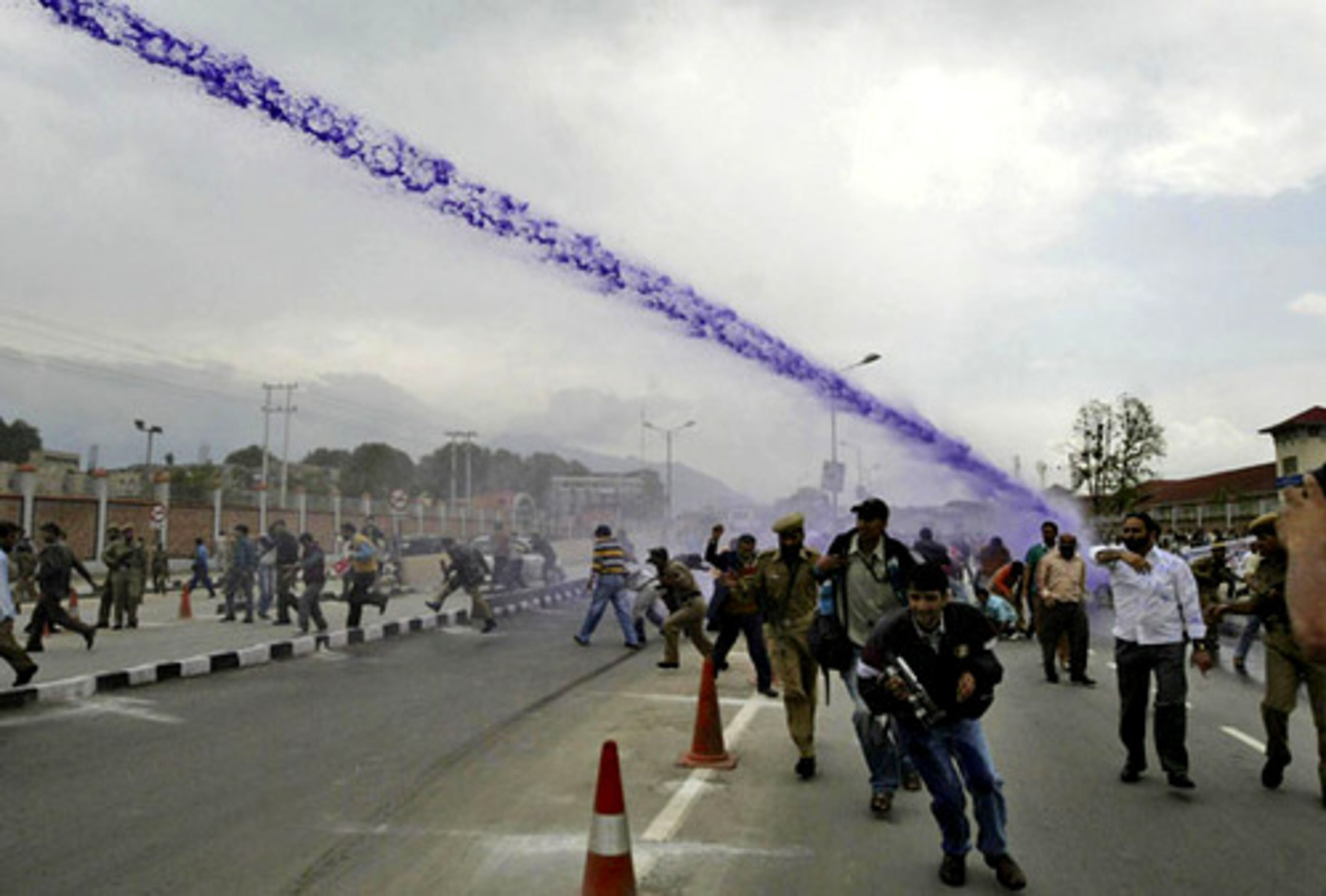 Police use colored water cannons to disperse Jammu Kashmir state government employees shouting anti-government slogans outside the civil secretariat in Srinagar, India, on Monday. The employees were demanding regularization of their jobs and a pay hike.