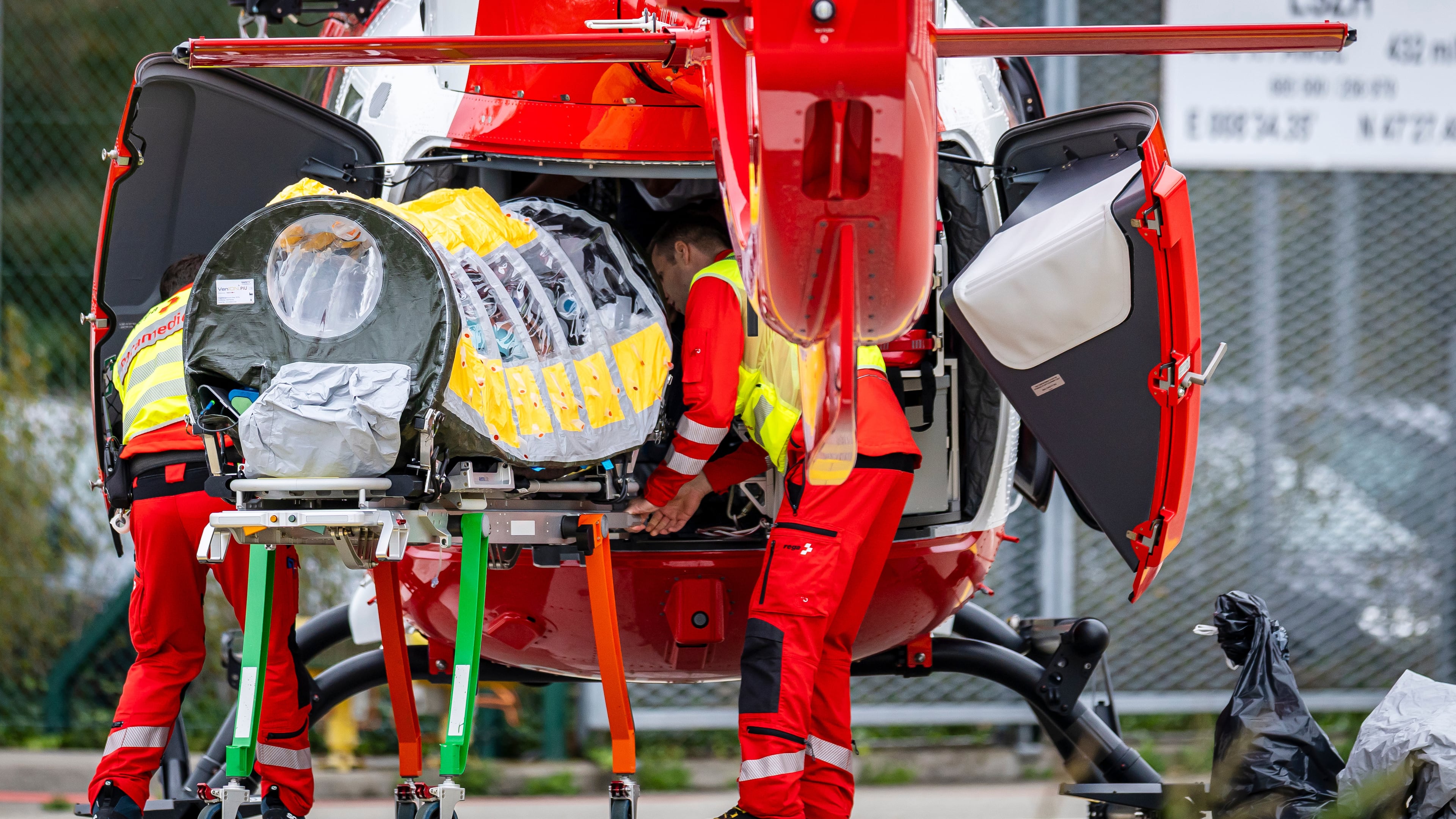 A patient is being transferred in a isolation unit from a rescue aircraft to a rescue helicopter of Swiss Air Rescue at Zurich Airport on Monday, Oct. 26, 2026, in Zurich, Switzerland. (Michael Buholzer/Keystone via AP)