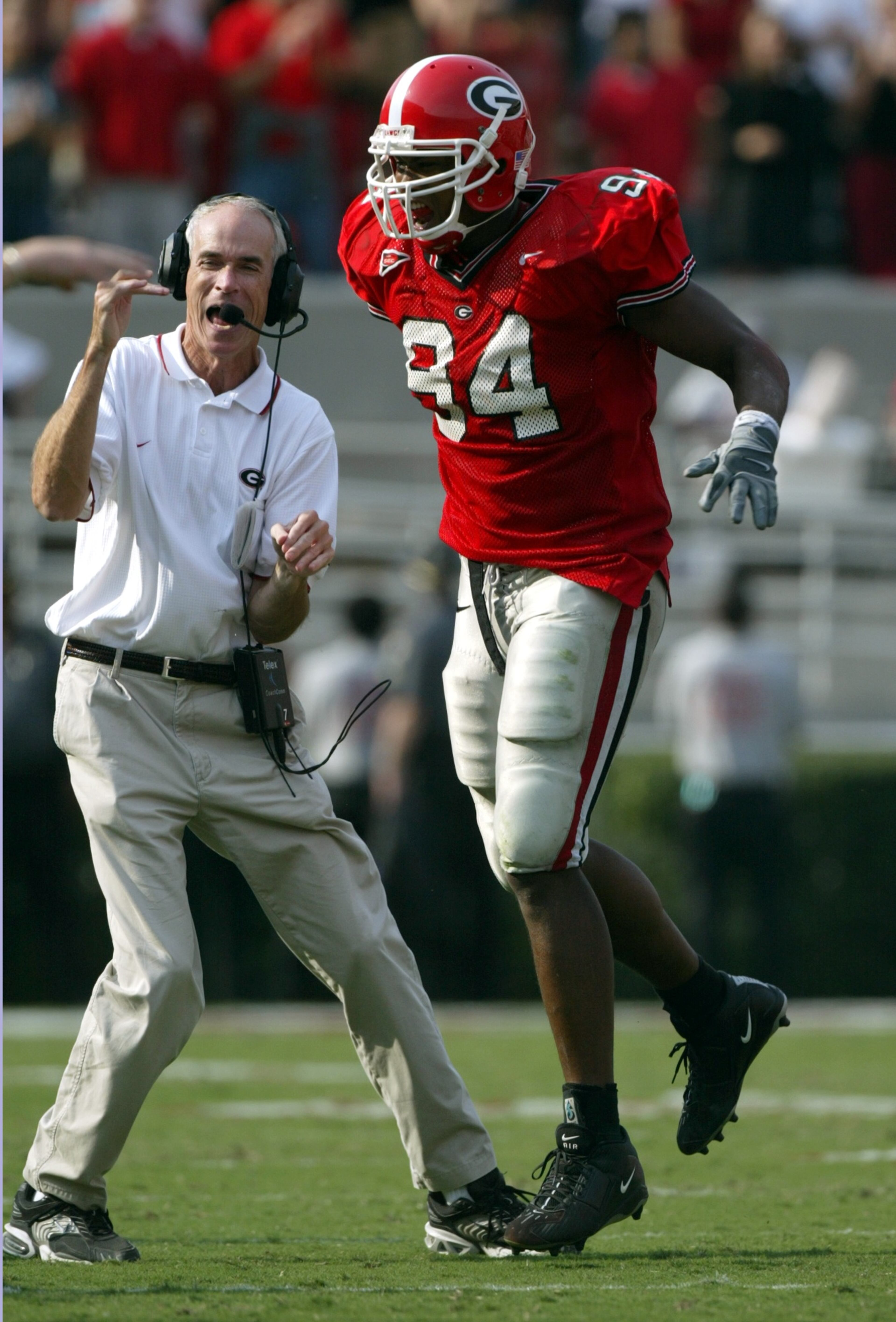 031025 Athens: UGA defensive ends coach Jon Fabris , left, celebrates with Quentin Moses after Moses pressered UAB's quarterback on 3rd and 4th downs of UAB's final drive. (Brant Sanderlin photo/Staff)