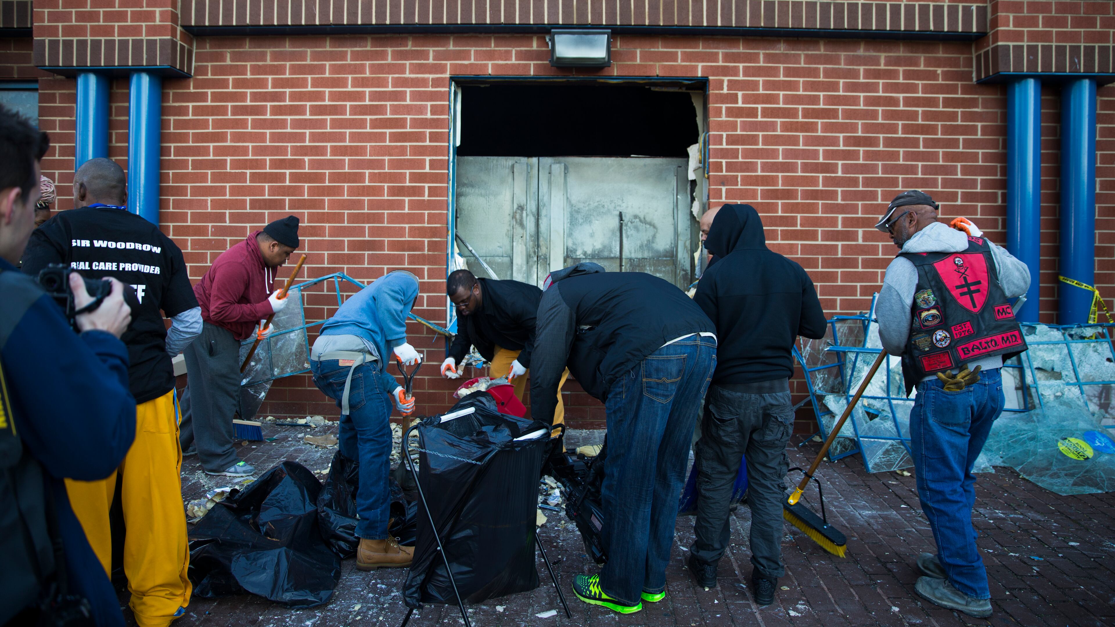 Maryland state troopers stand guard as residents clean up, Tuesday, April 28, 2015, after an evening of riots following the funeral of Freddie Gray on Monday, in Baltimore. (AP Photo/Evan Vucci)