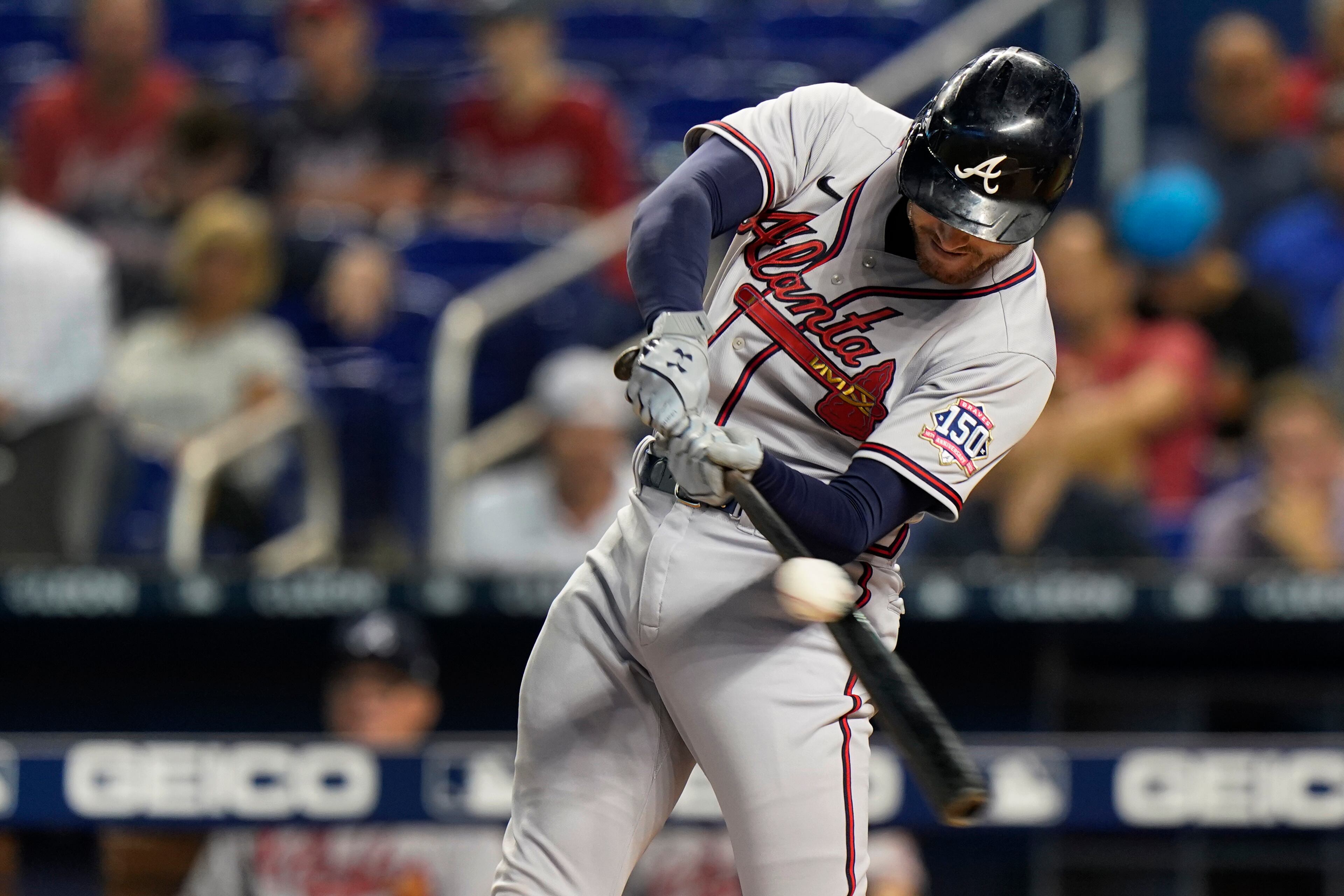 Atlanta Braves' Freddie Freeman hits the ball for a single during the first inning of the team's baseball game against the Miami Marlins, Tuesday, Aug. 17, 2021, in Miami. (AP Photo/Wilfredo Lee)