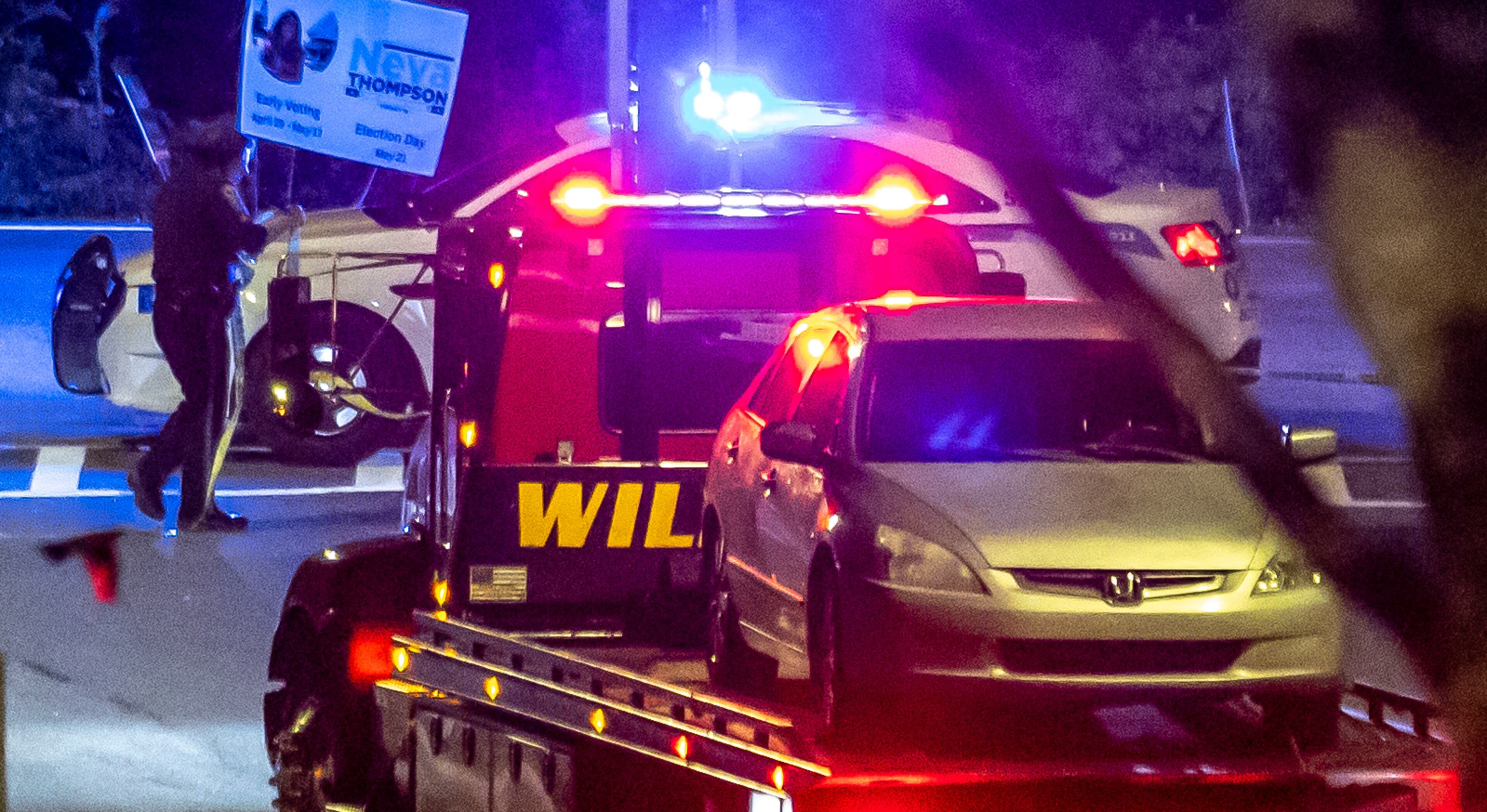 Investigators examine the scene of a shooting, where a man and three children shot to death inside a car at Lucky Shoals Park outside of Tucker on Wednesday, May 8, 2024. The man was in the driver’s seat. He, a boy and two girls all appeared to have been shot. Their names and ages were not released, but authorities said the children appeared to have been in elementary and middle school. (John Spink/AJC)