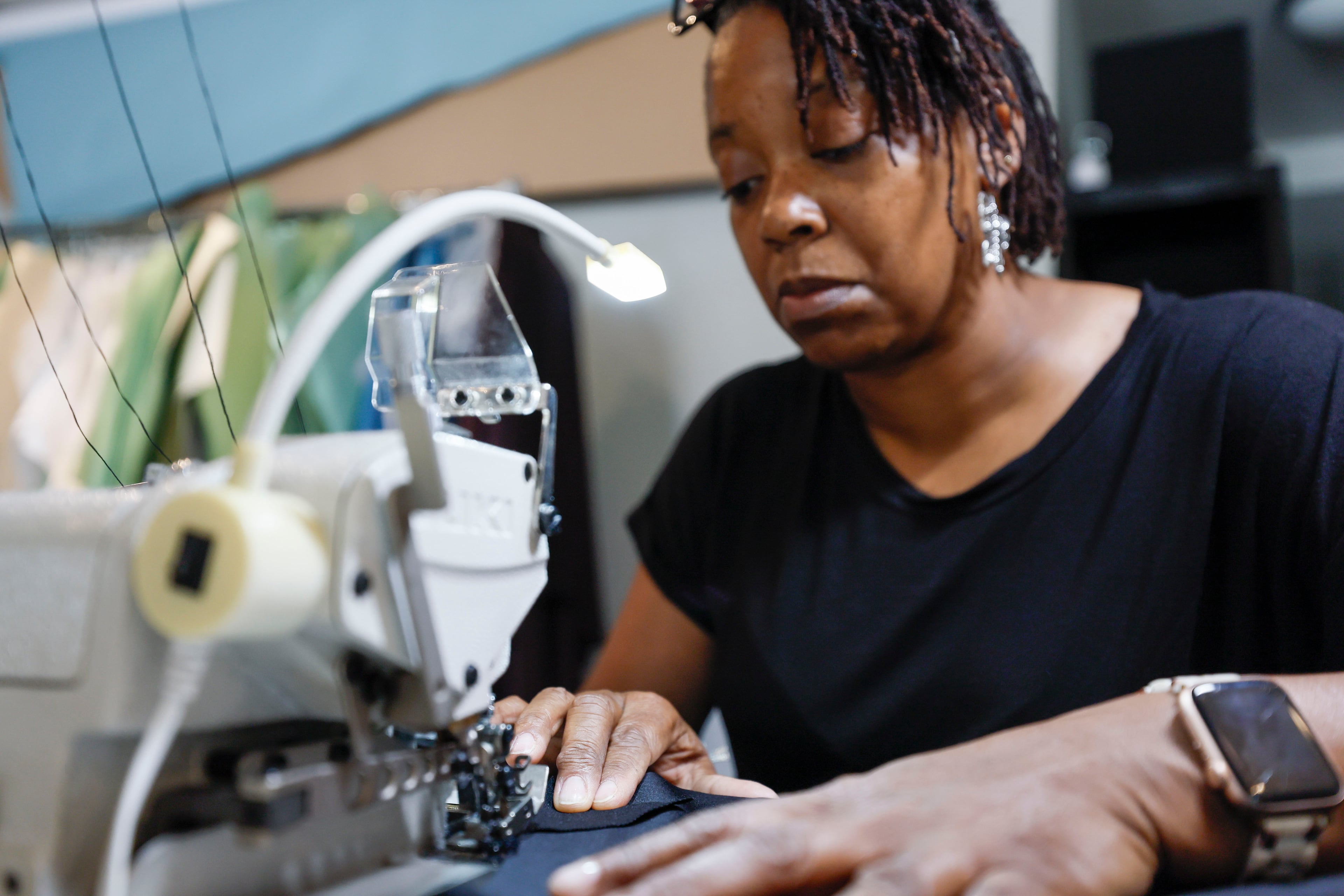Veronica Chapman, the lead sewist, working at Vertical Activewear studio in Duluth on Monday, May 5, 2025. Vertical Activewear may benefit from tariffs since all the fabrics and materials used are sourced from manufacturers within the United States.(Miguel Martinez/ AJC)