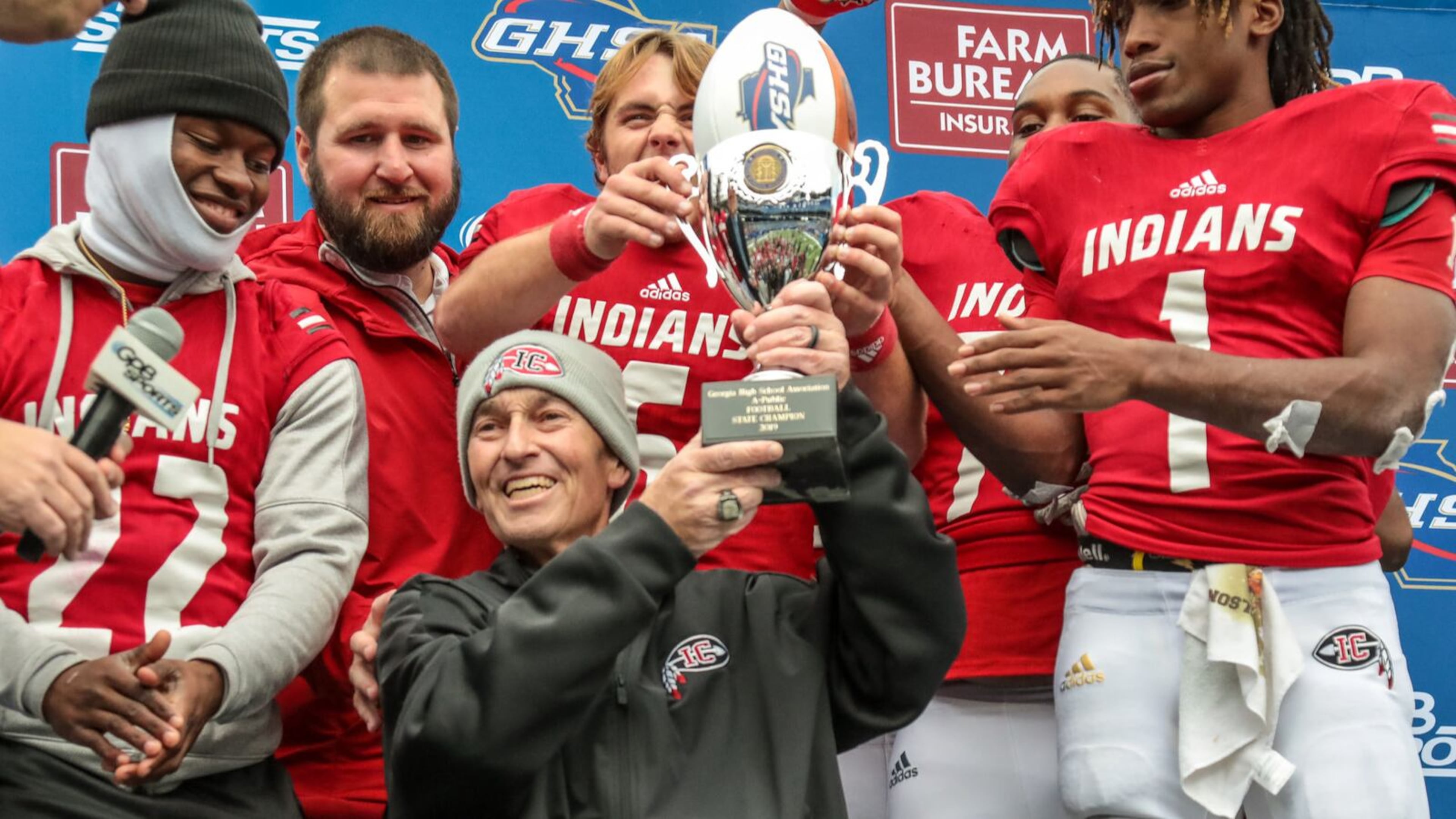 Buddy Nobles hold the Class A public-school championship trophy after Irwin County's victory in 2019. Nobles died the following year, and Irwin County remains a perennial state contender. (Courtesy of GHSA)
