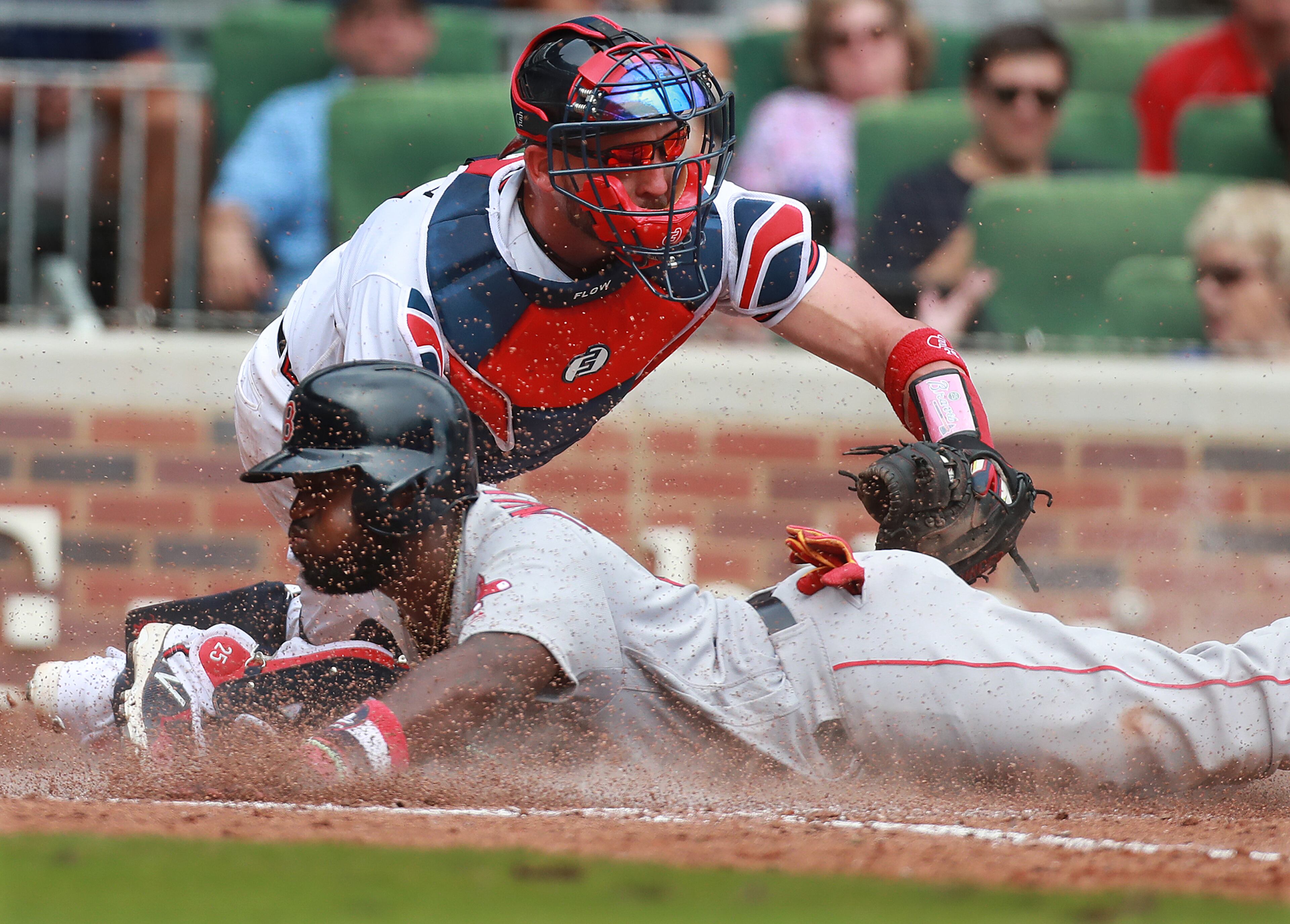 September 5, 2018 Atlanta: Boston Red Sox Brandon Phillips slides home safe past Atlanta Braves catcher Tyler Flowers to tie the game 7-7 on a 2-RBI single by Ian Kinsler during the 8th inning in a MLB baseball game on Wednesday, Sept 5, 2018, in Atlanta. Phillips hit a 2-run homer in the 9th inning to beat the Braves 9-8. Curtis Compton/ccompton@ajc.com