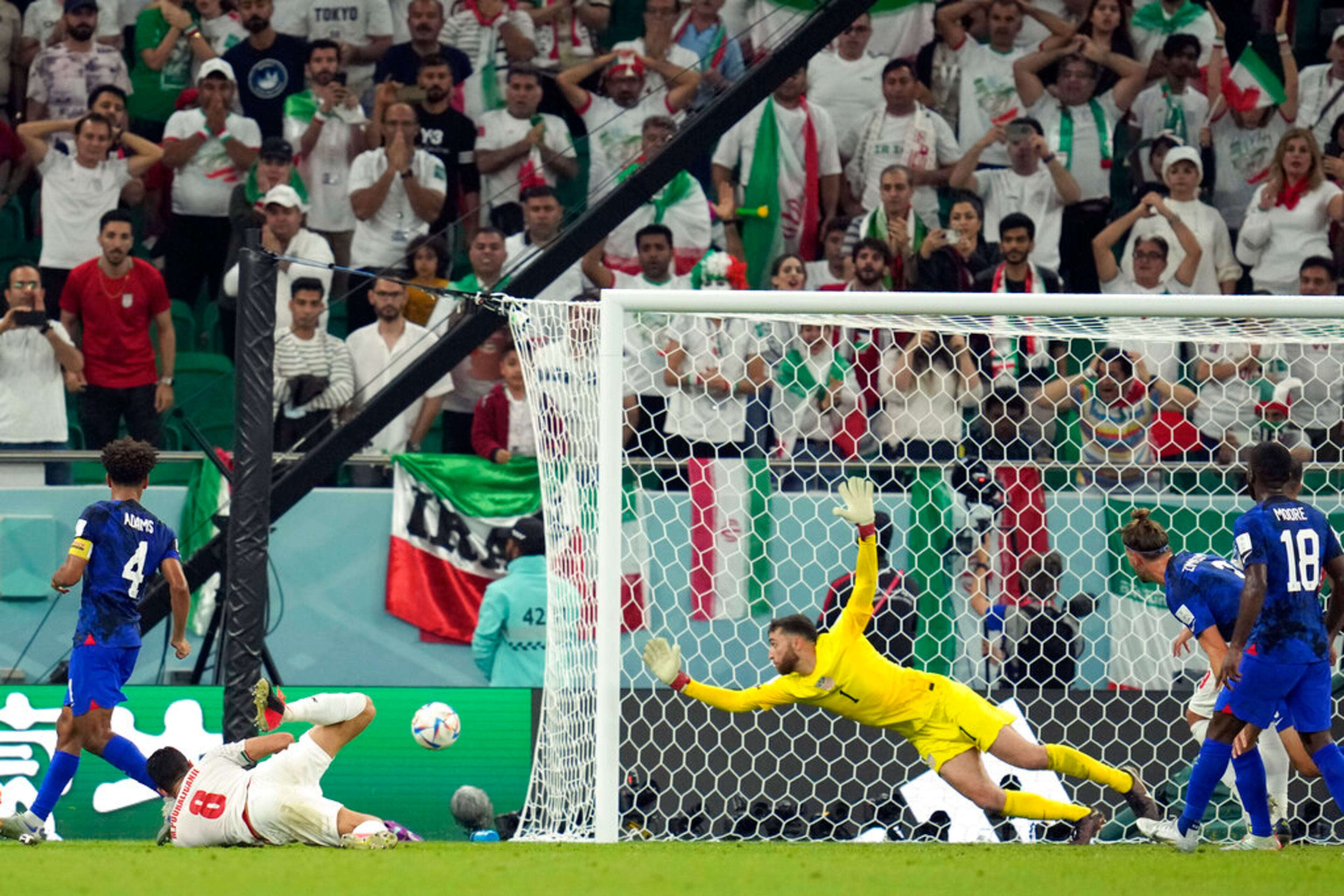 Iran's Morteza Pouraliganji (8) heads wide of goal against United States' goalkeeper Matt Turner (1) during the World Cup group B soccer match between Iran and the United States at the Al Thumama Stadium in Doha, Qatar, Tuesday, Nov. 29, 2022. (AP Photo/Ashley Landis)