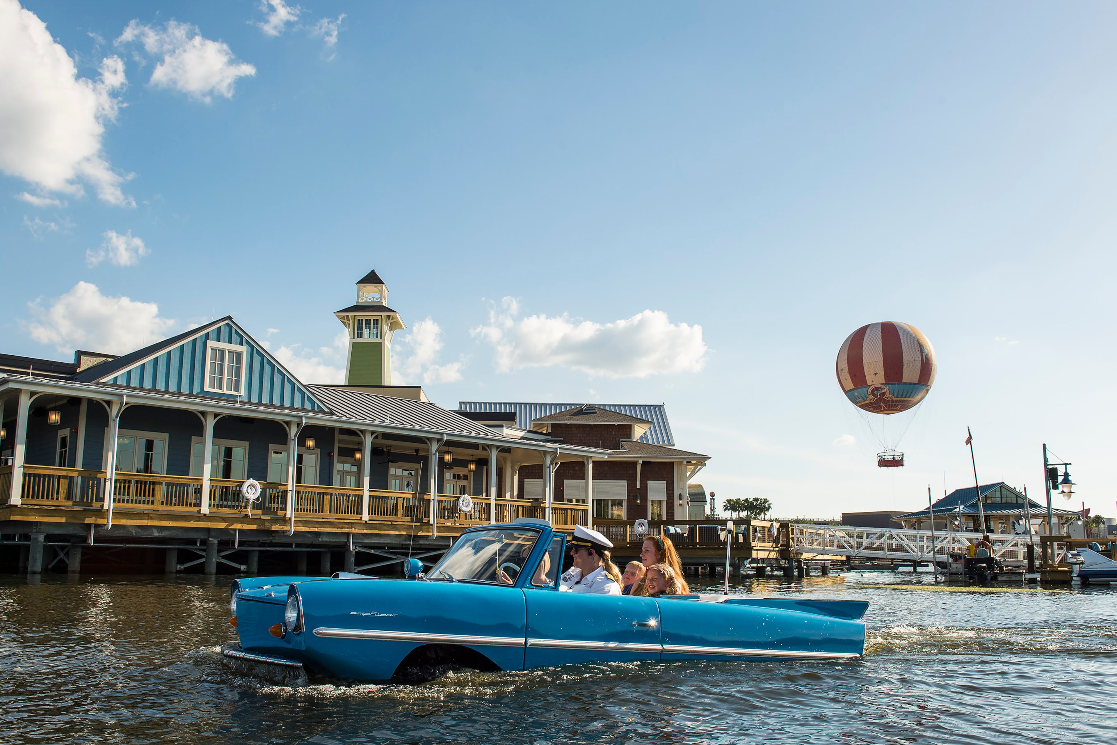 Guests go for a ride in a Captain-guided tour aboard an amphibious auto, known as an Amphicar, on Lake Buena Vista at Downtown Disney, as part of the waterfront adventures offered at The BOATHOUSE restaurant.