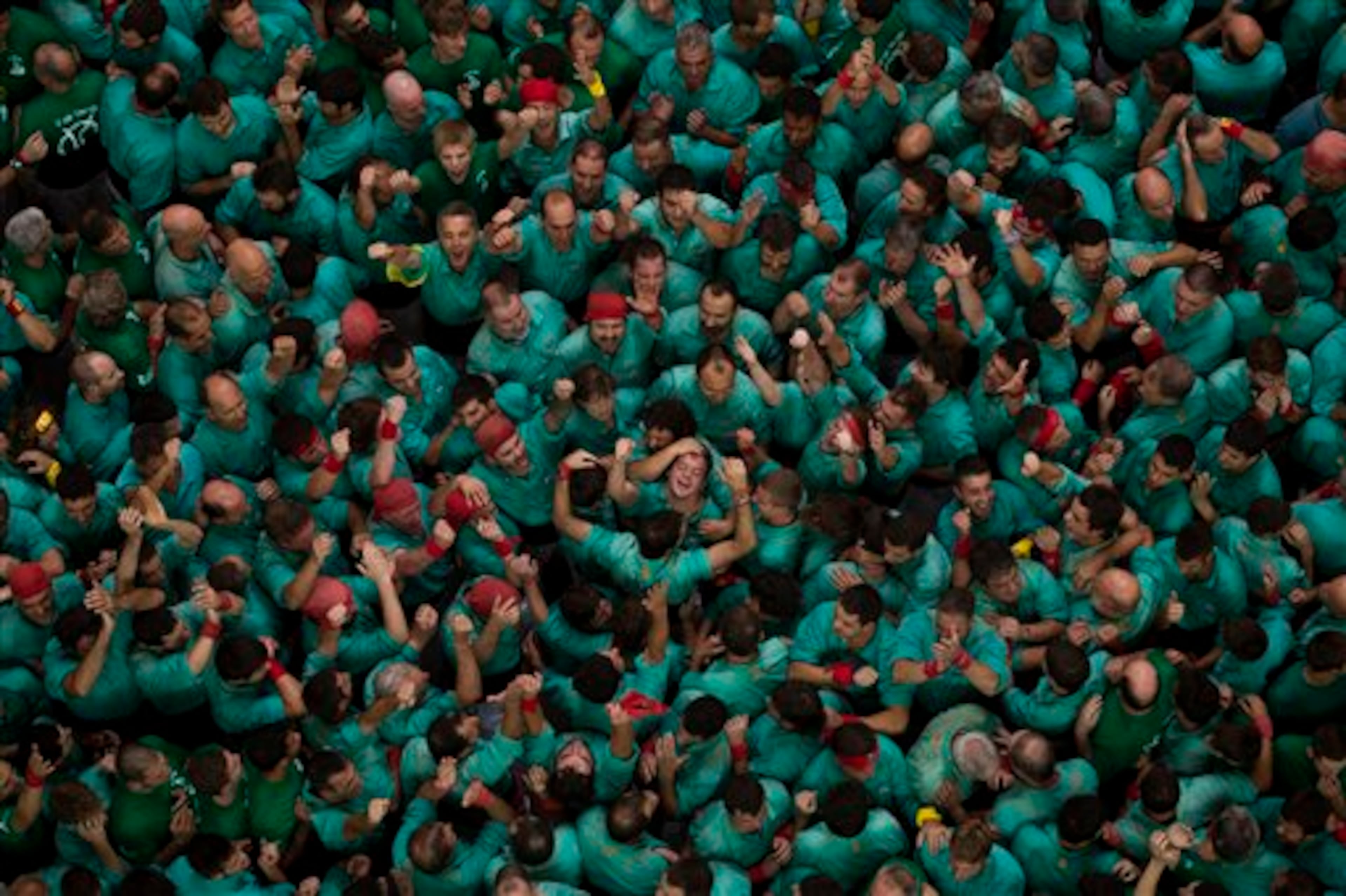 Members of the Castellers de Villafranca celebrate after finishing their human tower during the 25th Human Tower Competition in Tarragona, Spain, on Sunday, Oct. 5, 2014. The tradition of building human towers or �castells� dates back to the 18th century and takes place during festivals in Catalonia, where �colles� or teams compete to build the tallest and most complicated towers. The structure of the �castells� varies depending on their complexity. A �castell� is considered completely successful when it is loaded and unloaded without falling apart. The highest �castell� in history was a 10 floor structure with 3 people in each floor. In 2010 �castells� were declared by UNESCO one of the Masterpieces of the Oral and Intangible Heritage of Humanity. (AP Photo/Emilio Morenatti)
