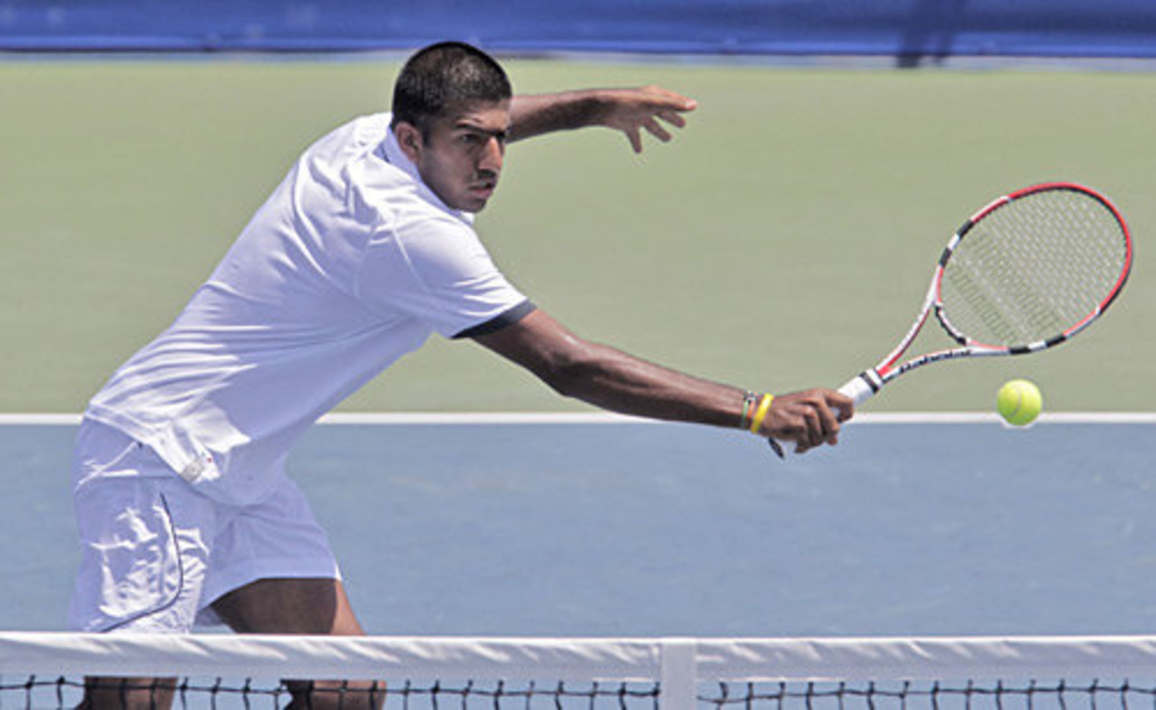 Rohan Bopanna (IND) returns a volley in the doubles match won by Scott Lipsky (USA) and Rajeev Ram (USA) in a tie breaker.