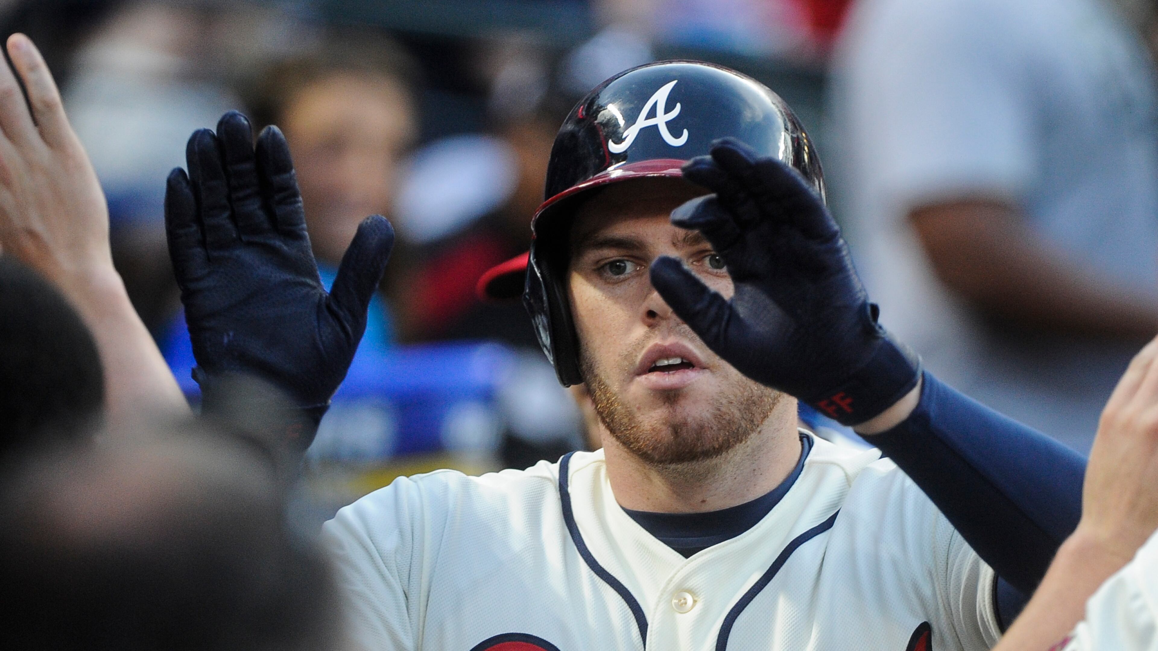 Freddie Freeman is congratulated after a home run against the Mets on April 11. (AP Photo/John Amis)