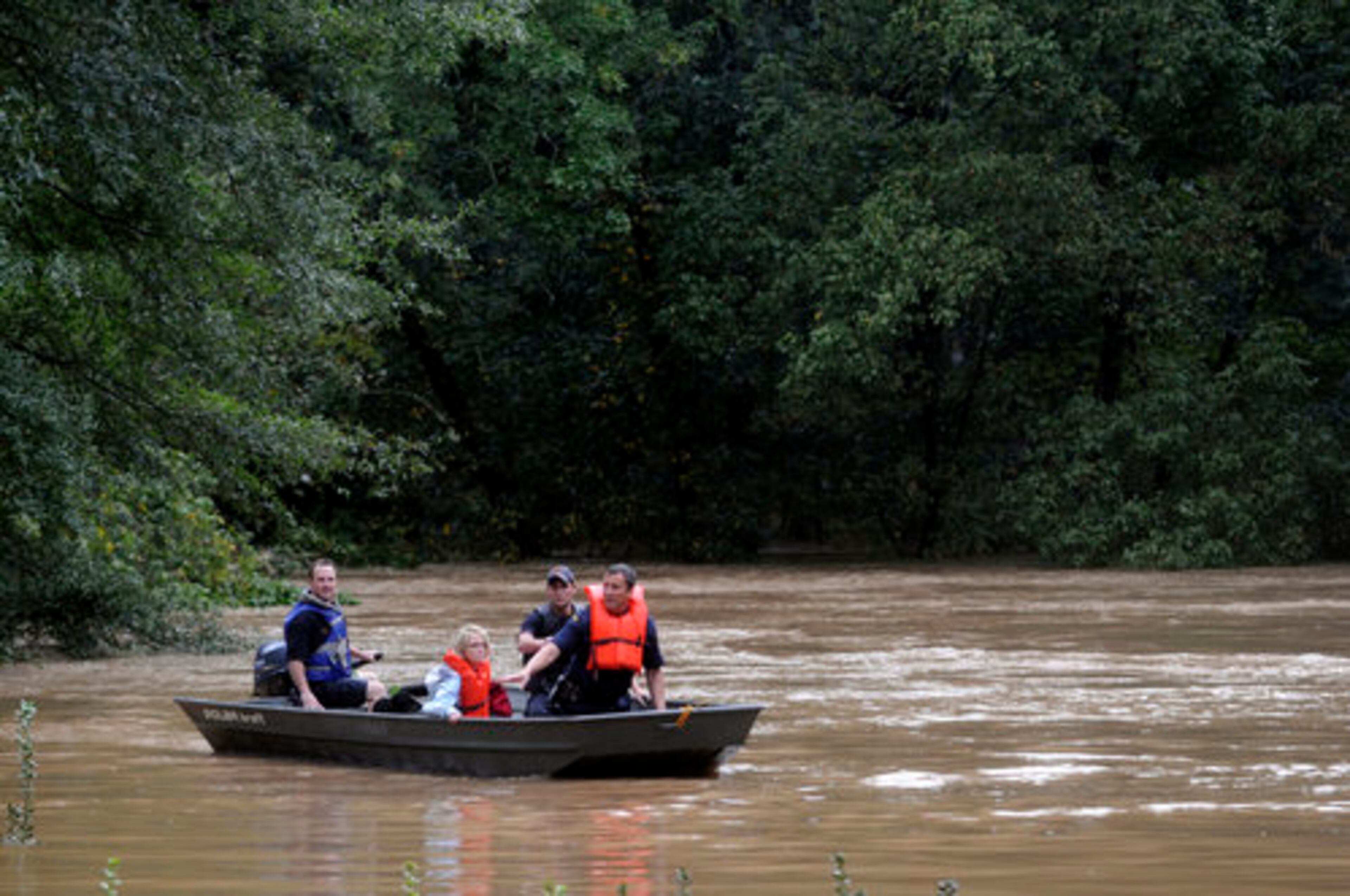 Jennifer VanNess, 36, takes a boat to safety after rescue crews picked her up near Peachtree Battle Ave. and Arden Road in Atlanta.