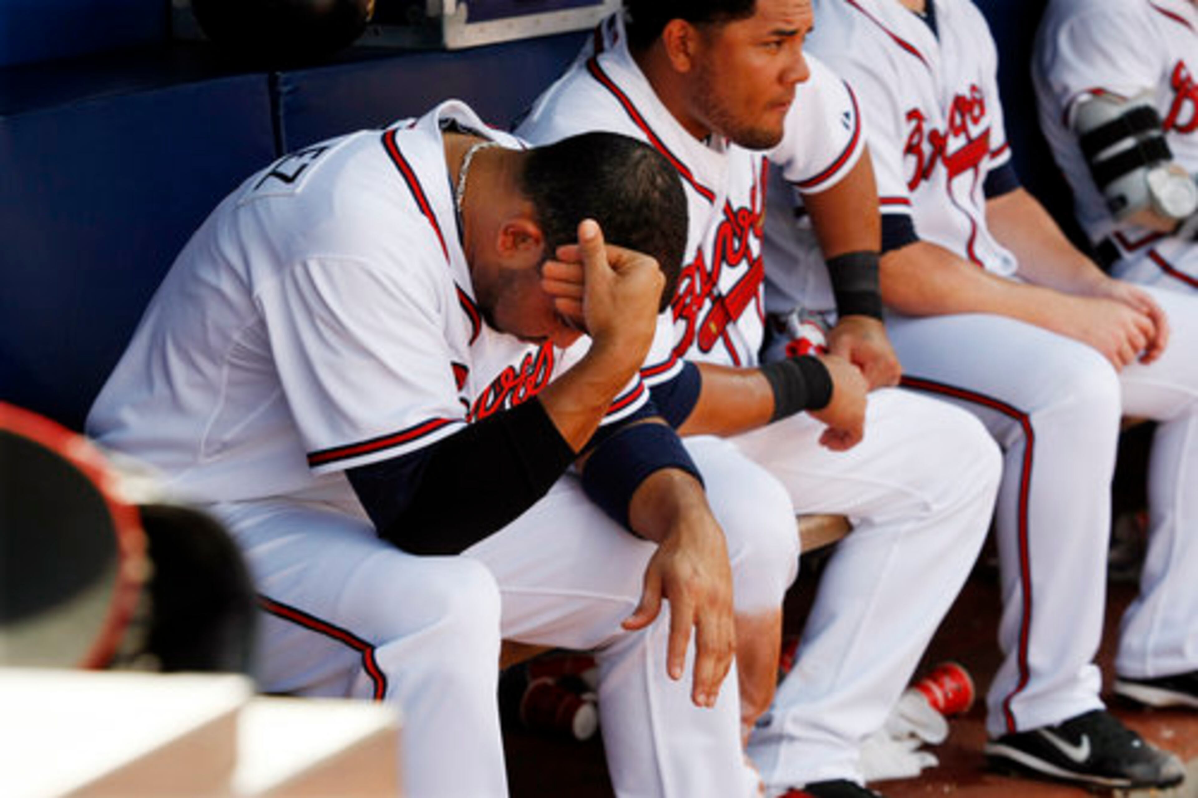 Atlanta Braves Alex Gonzalez, left, and Melky Cabrera, right, sit dejected in the dugout during the final out of the 9th inning as the Braves fall 4-2 to the Washington Nationals losing the rubber game at Turner Field in Atlanta on Wednesday, Sept. 15, 2010.